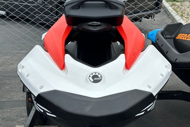 A Sea-Doo PWC SPARK TRIXX 90 with a striking design, parked on a trailer.