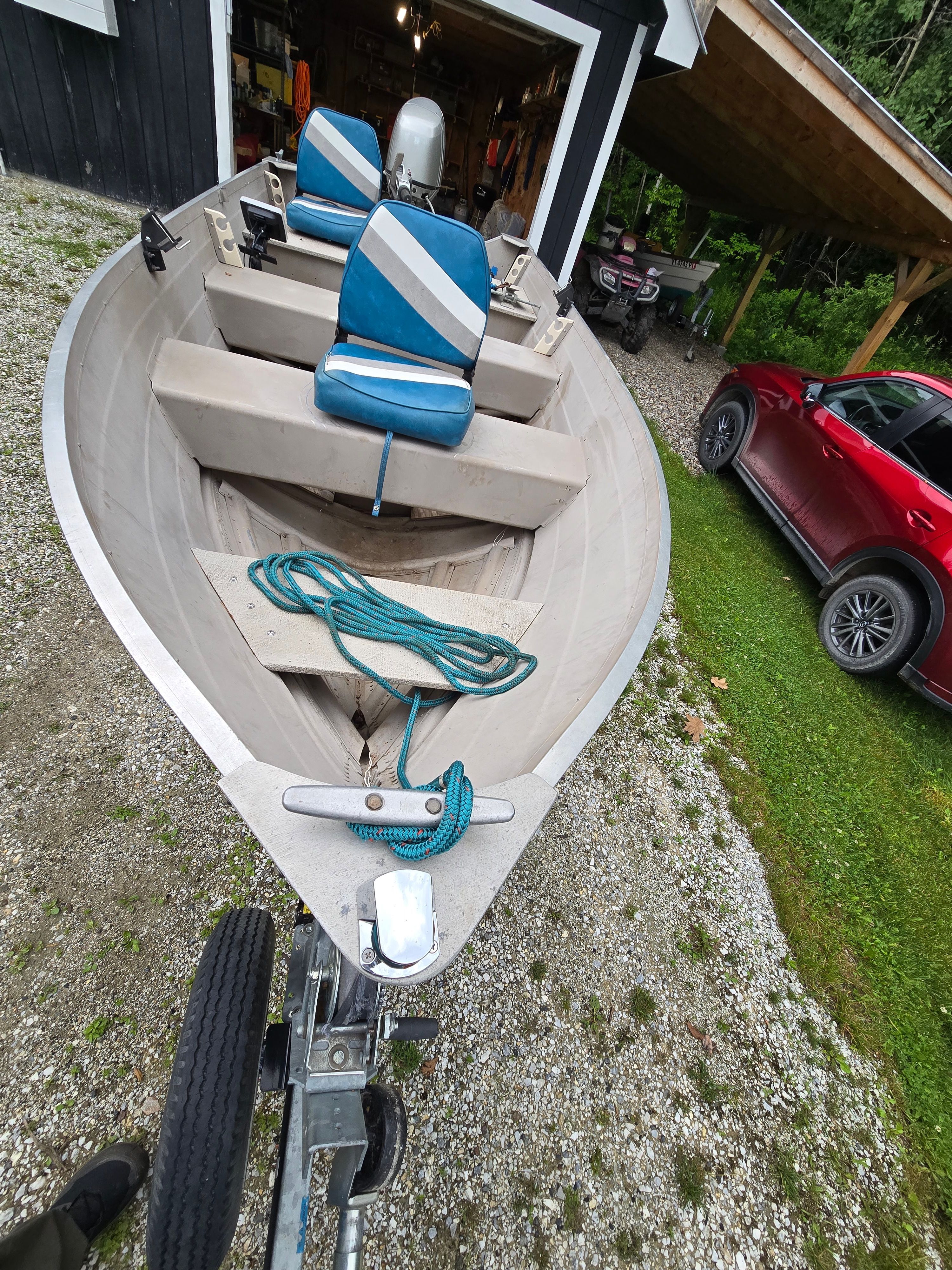 A 2002 Starcraft SF 14 L SS Utility Boat is on a trailer outdoors.