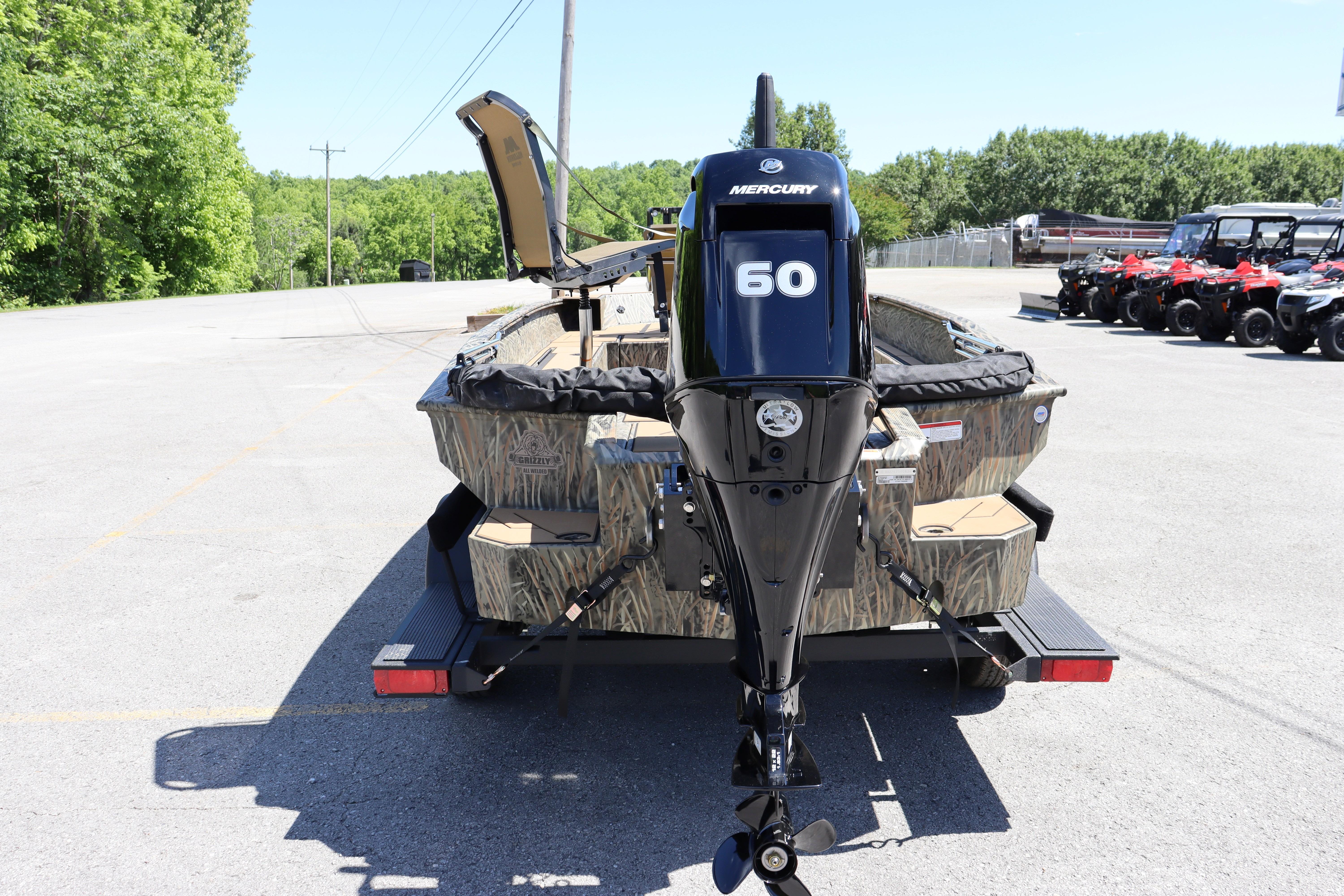 2026 Tracker Grizzly 1756 T Marsh boat with Mercury 60 engine, parked outdoors.