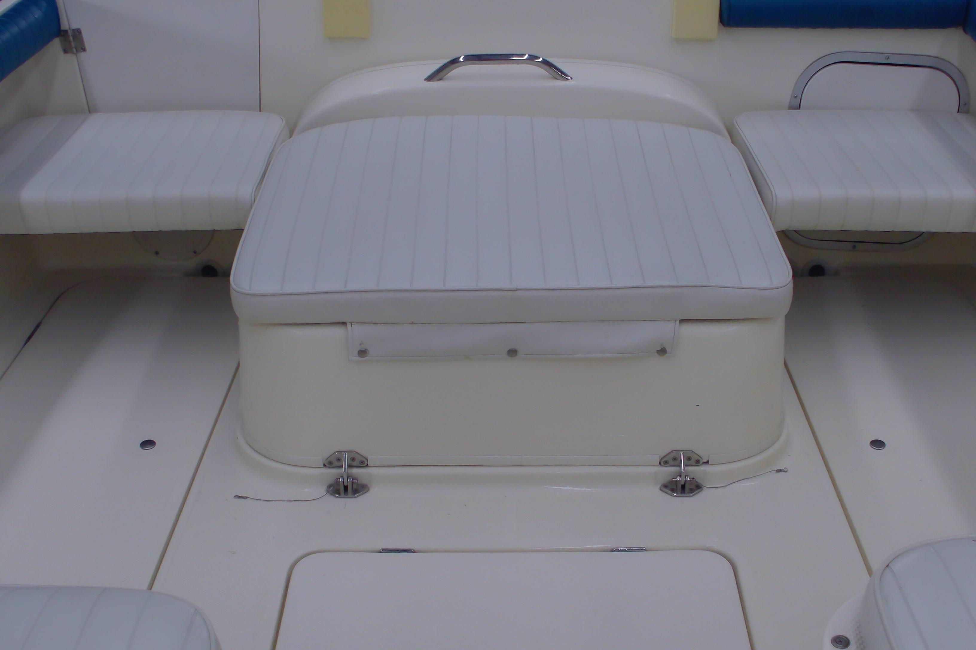 2004 Trophy 2352 Walkaround boat interior with cushioned seating and storage.