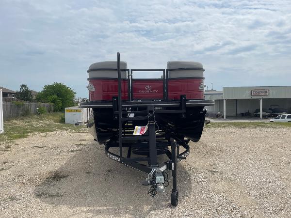 2023 Regency 250DL3 pontoon boat on trailer, parked outdoors.
