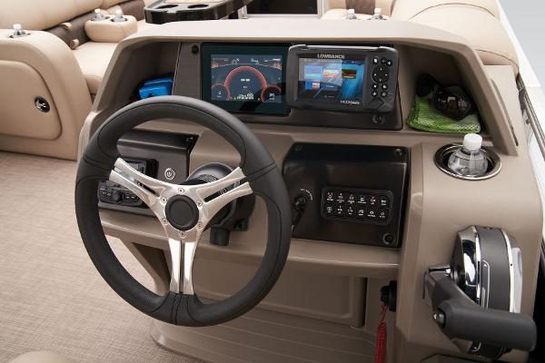 2024 Sun Tracker SportFish 22 DLX boat dashboard with steering wheel and navigation controls.