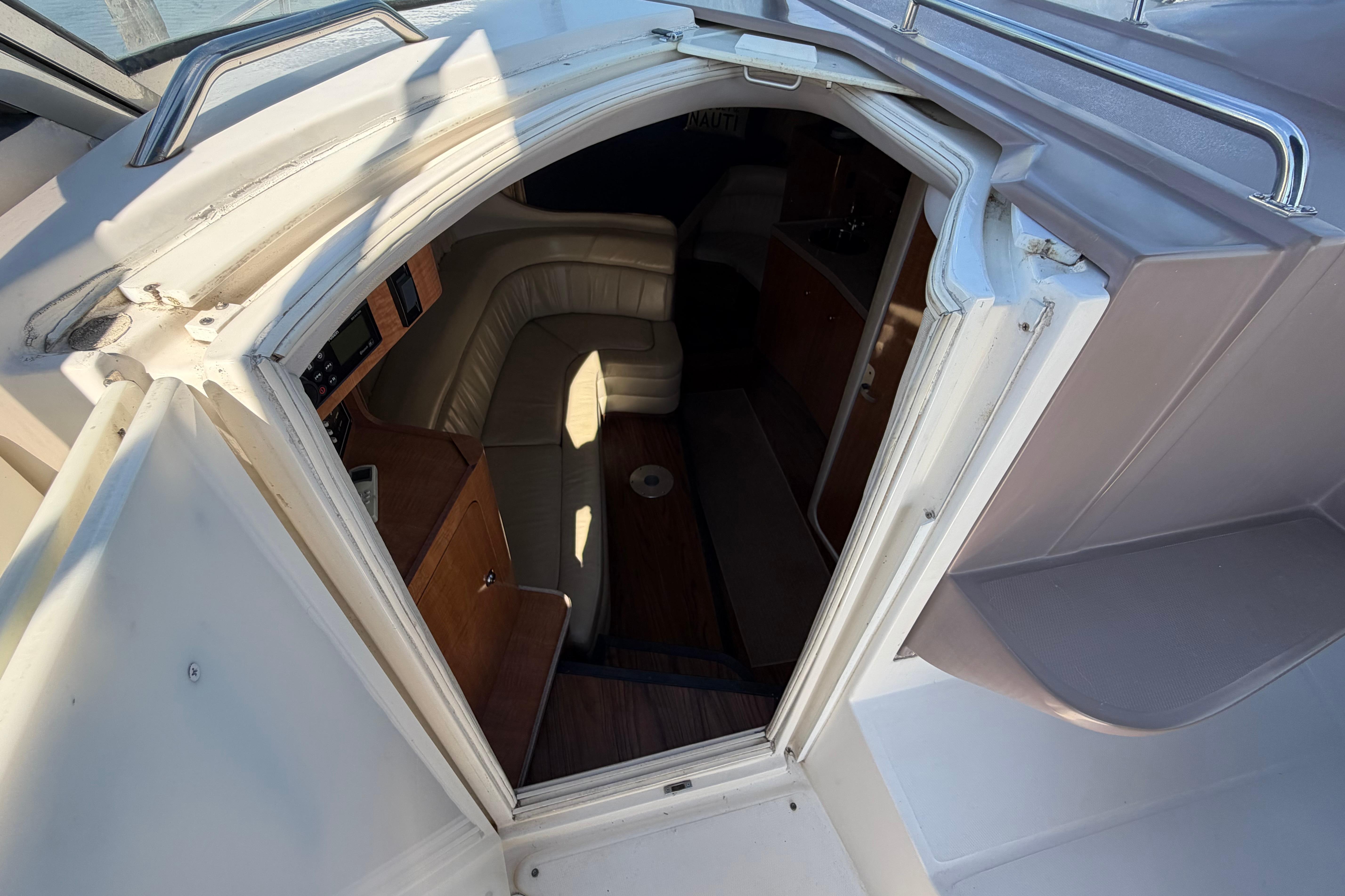 Interior view of 2003 Regal Commodore 3260 boat cabin with seating area.