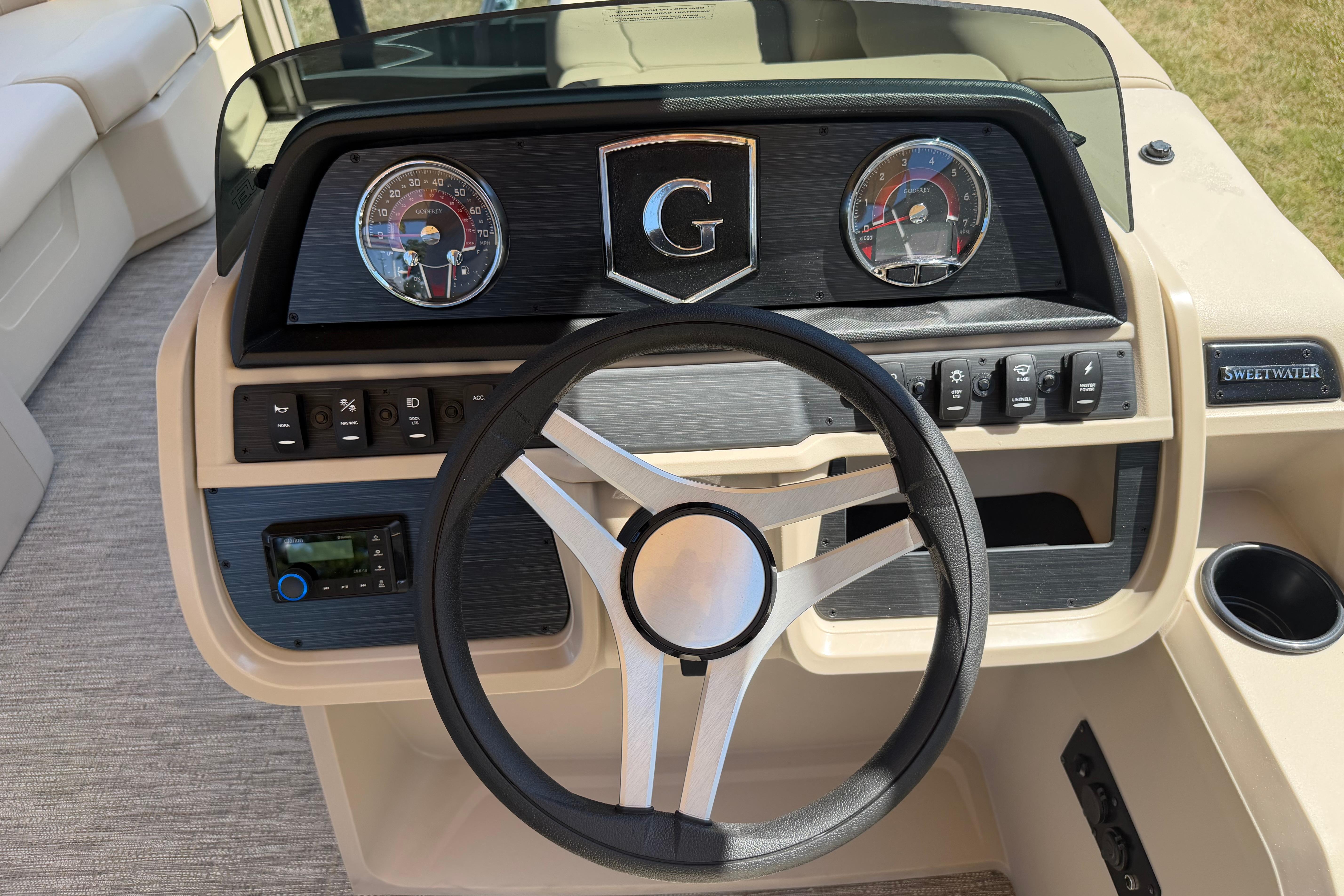 Steering console of 2026 Godfrey SW 2086 SBC boat with gauges and controls.