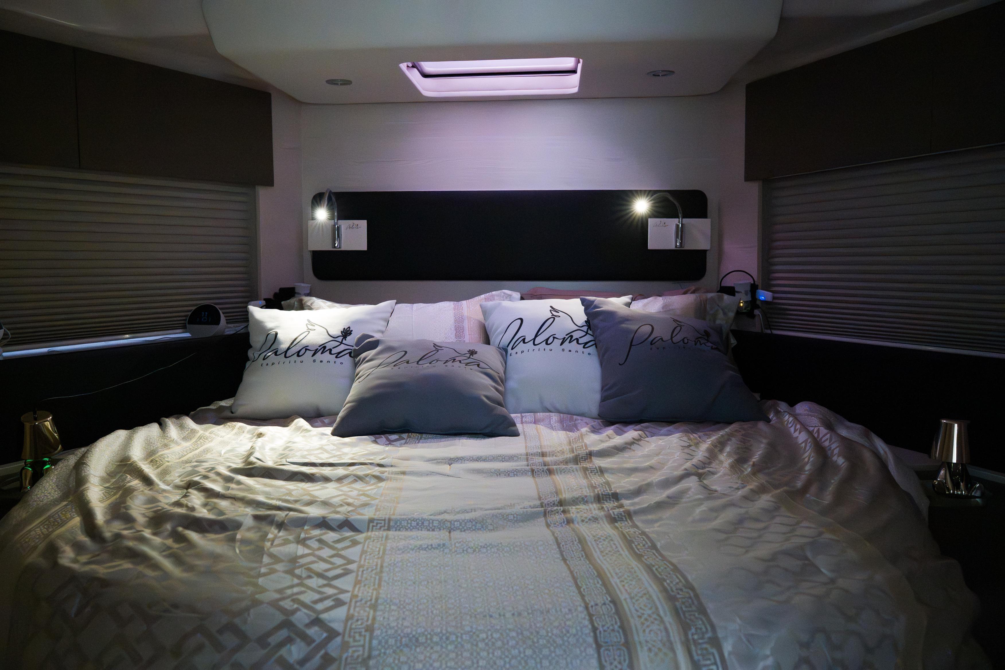 Luxurious bedroom interior of 2019 Azimut Fly 50 yacht with elegant bedding and ambient lighting.