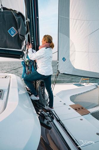 Person sailing on a 2025 Nautitech 40 Open catamaran.