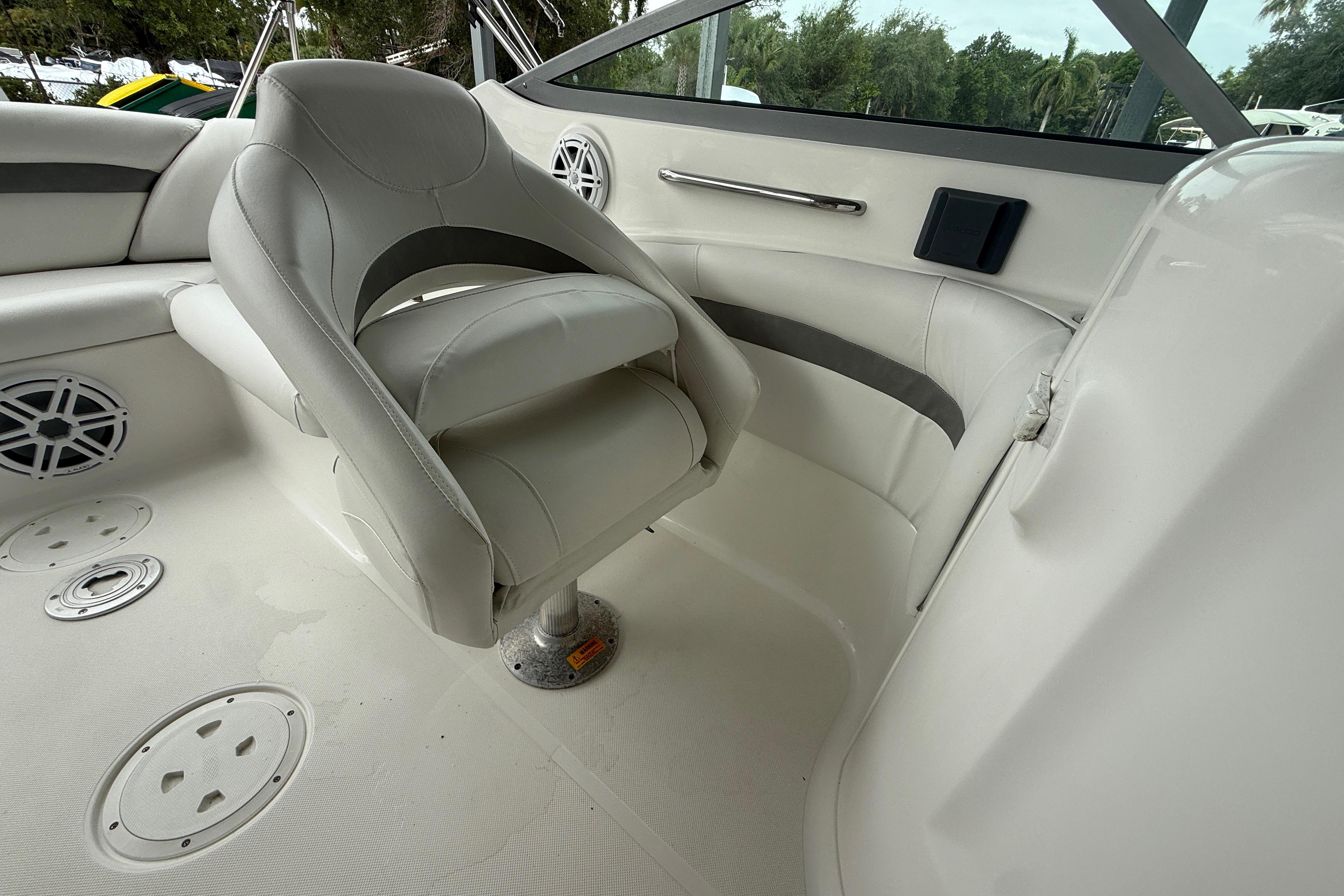2014 Hurricane SunDeck 2400 OB boat interior with white seating and speaker system.