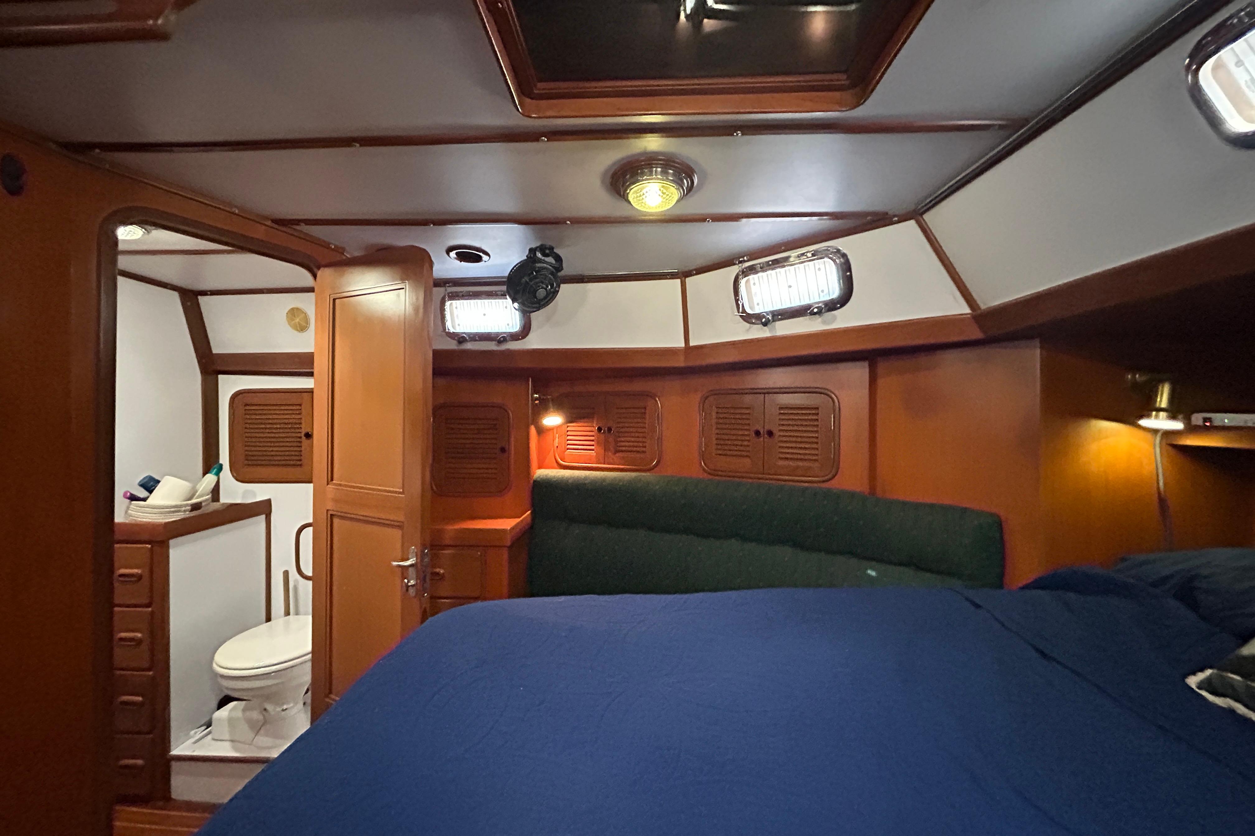 Interior of 1995 Tayana 48 yacht cabin with bed and bathroom.