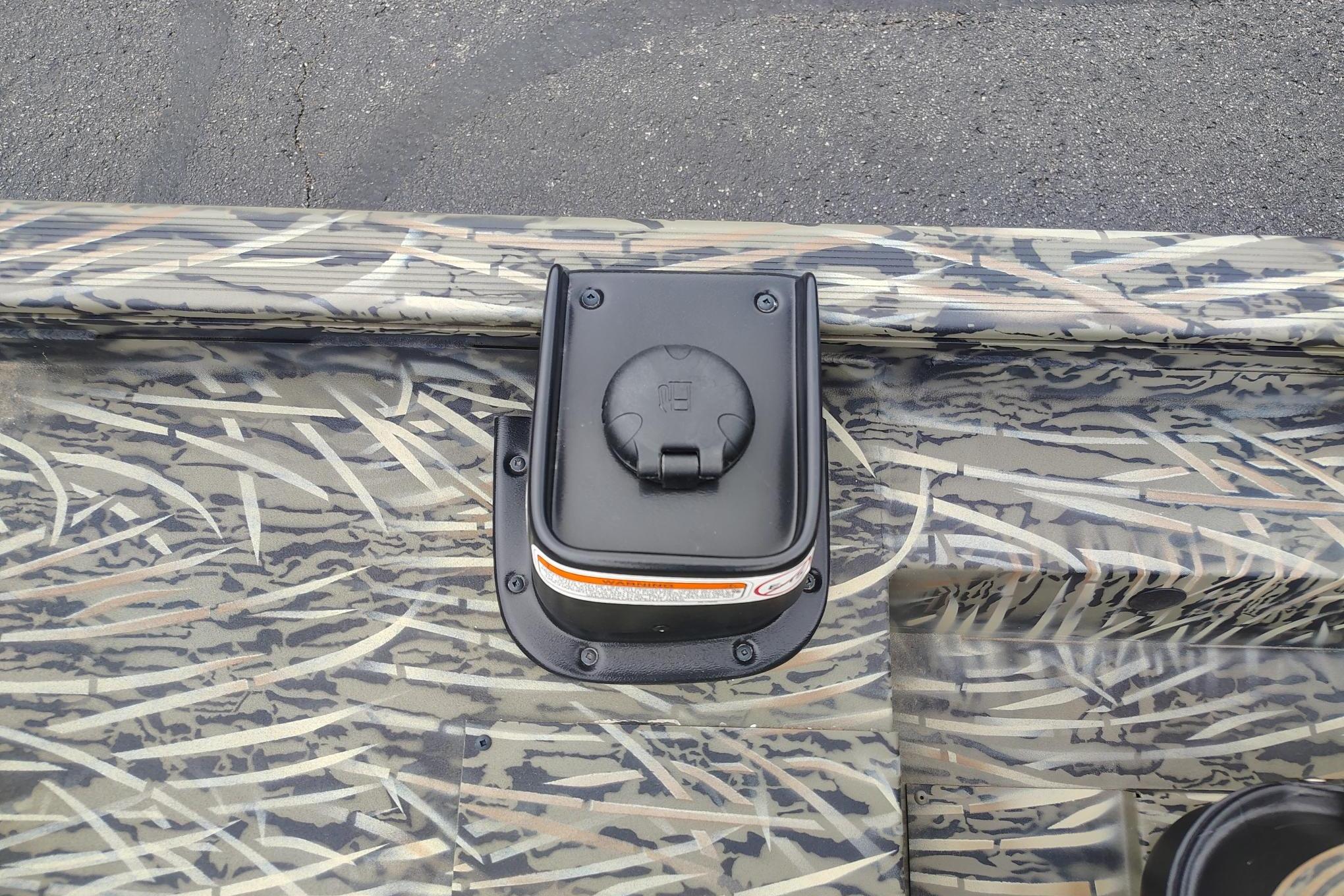Camouflage-patterned Tracker Grizzly 1754 SC boat detail, featuring a mounted black accessory.
