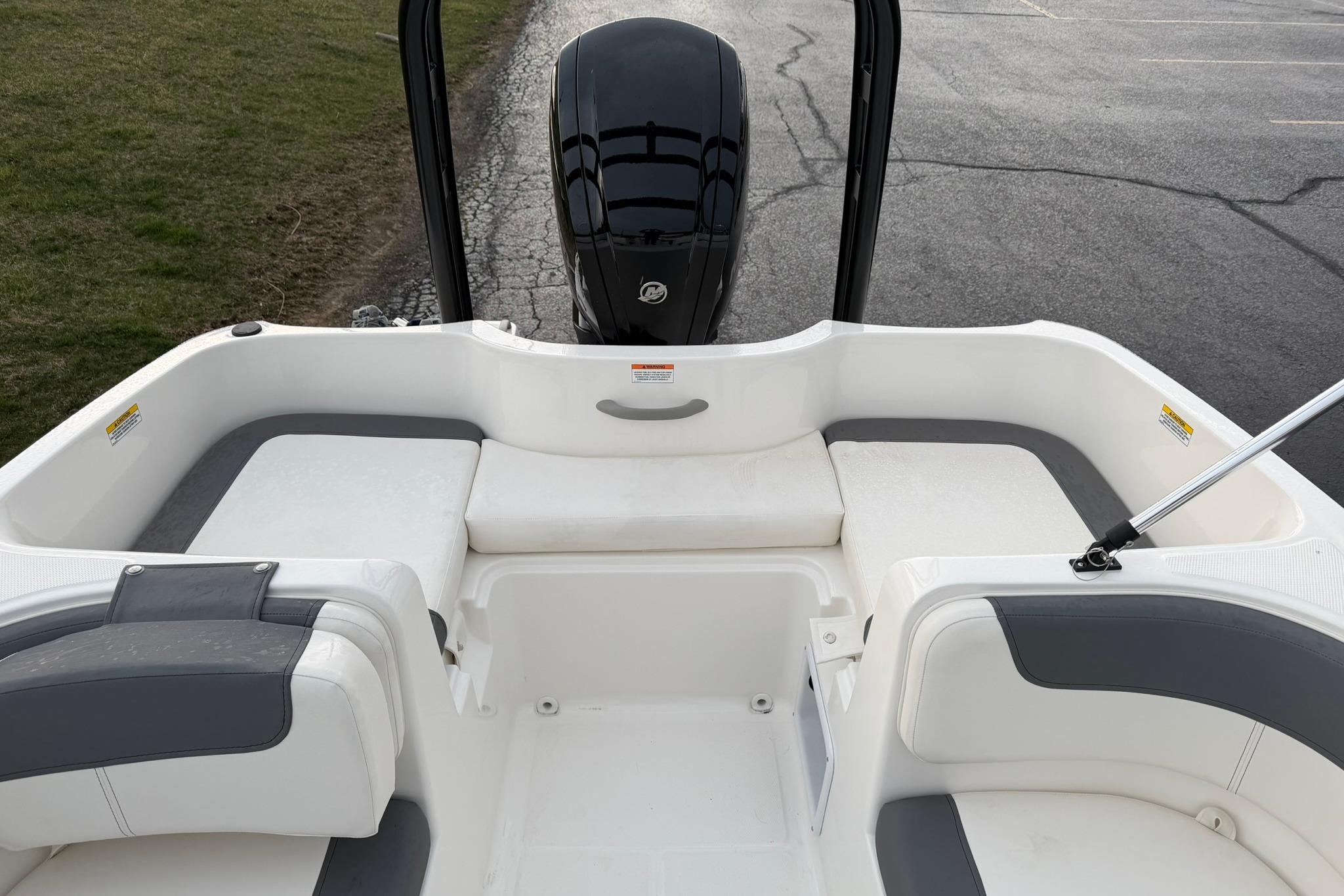 2026 Bayliner Element E16 boat interior with seating and outboard motor.