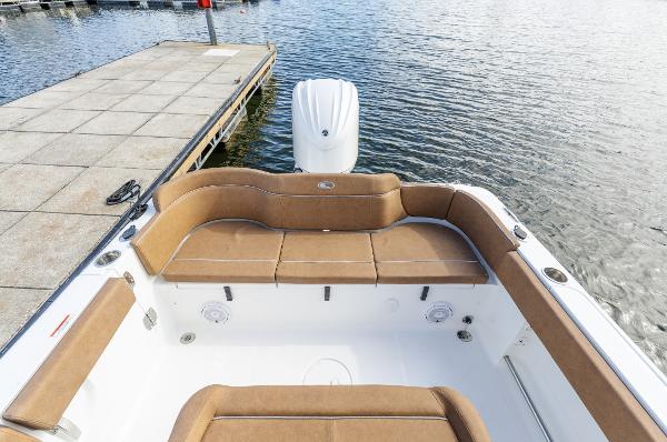 2025 Sea Hunt Ultra 235 SE boat interior with tan seating at dock.