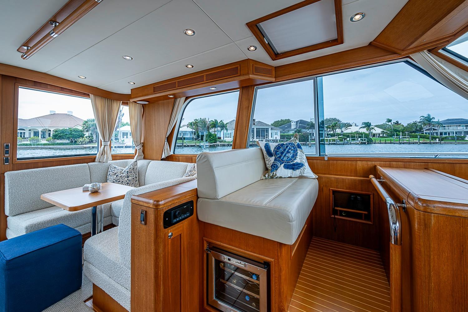 Luxurious interior of 2014 Grand Banks 46 Eastbay SX yacht with elegant seating and large windows.