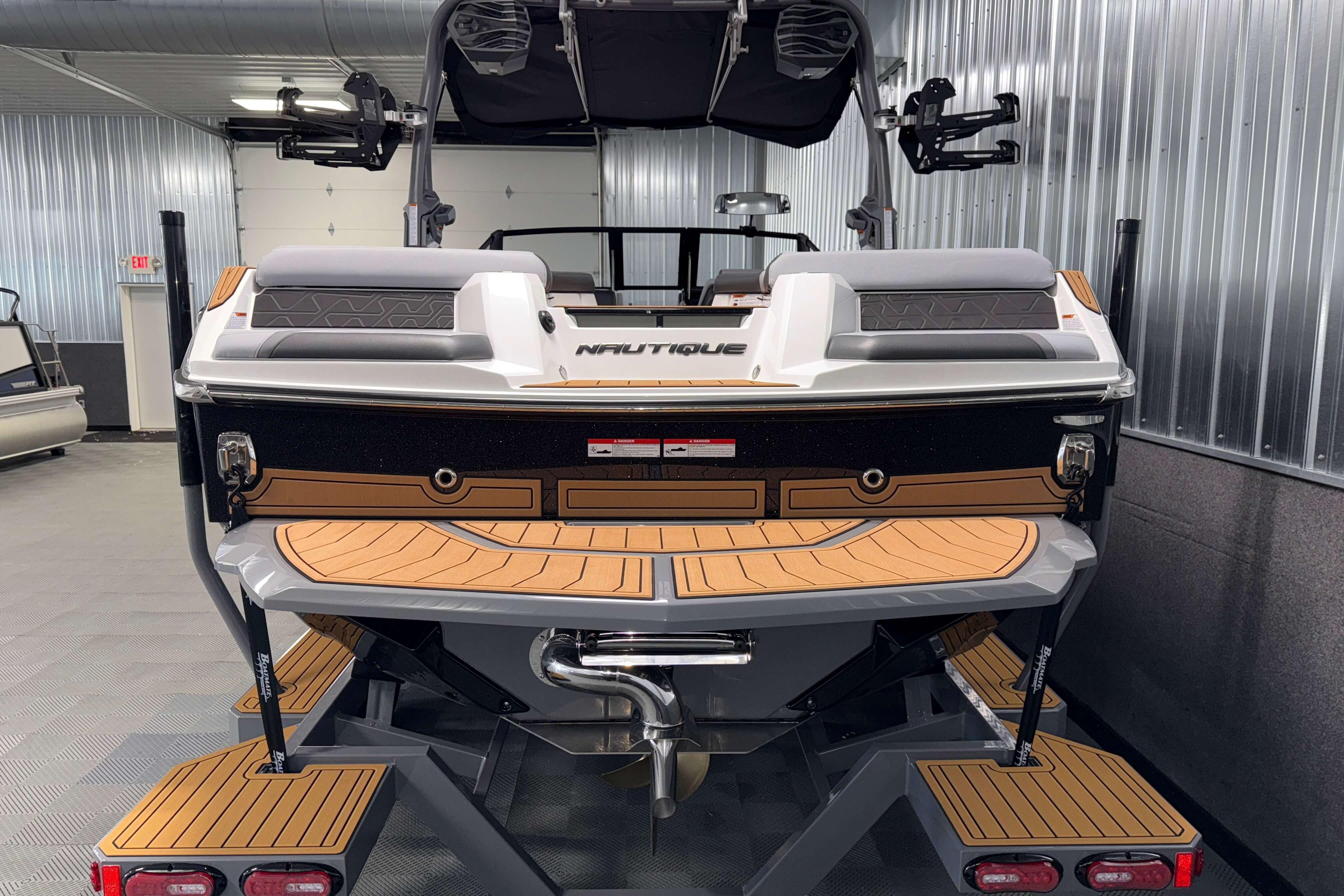 2026 Nautique Super Air Nautique GS22 boat in showroom, rear view.