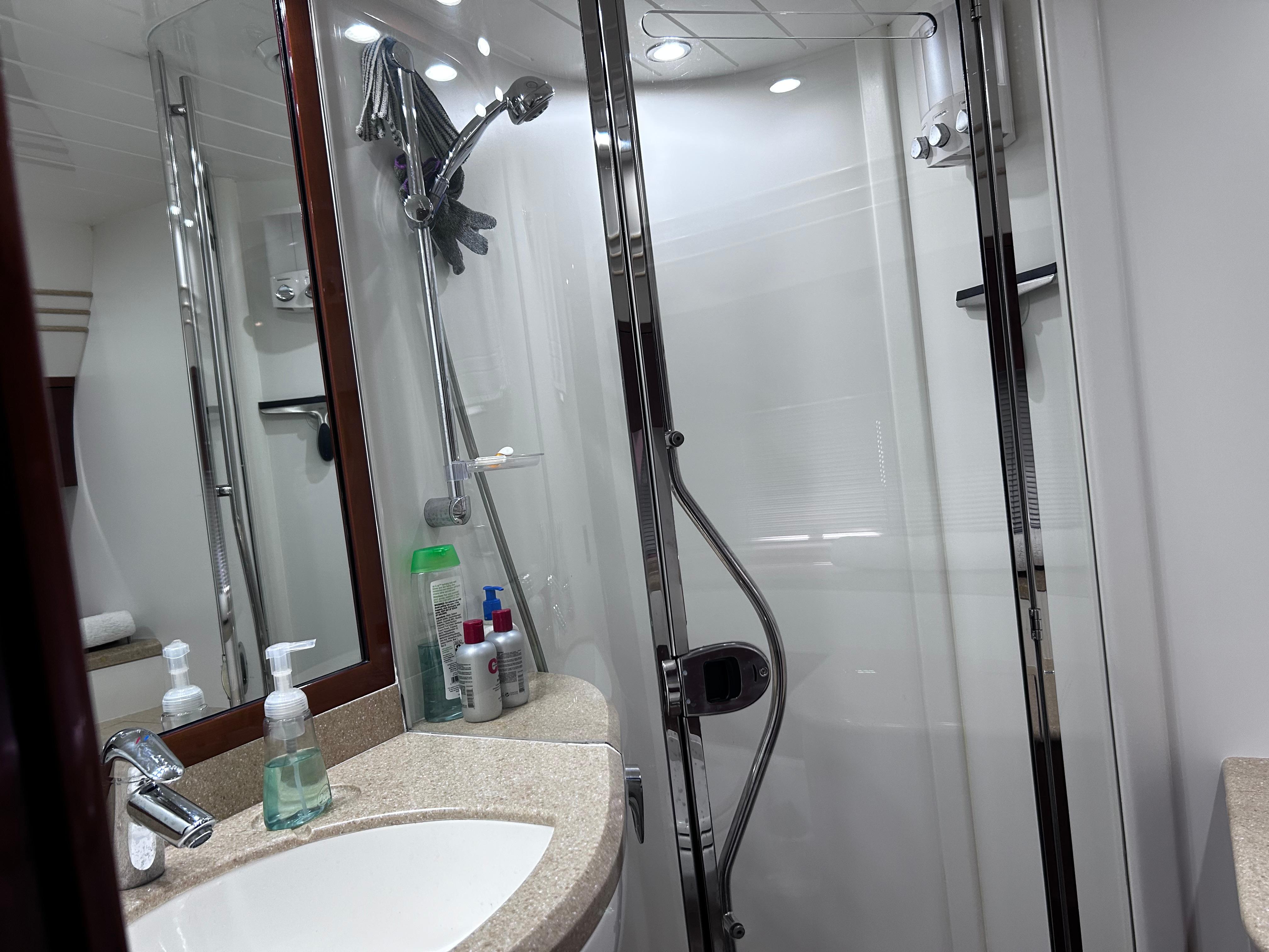 Luxurious bathroom in 2006 Viking Princess 61 Flybridge yacht with modern shower and sink.