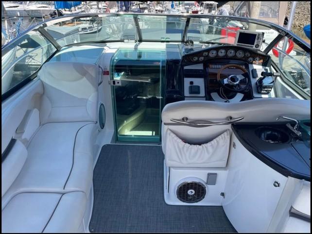 2008 Doral Elegante boat interior with white seating, control panel, and glass door.