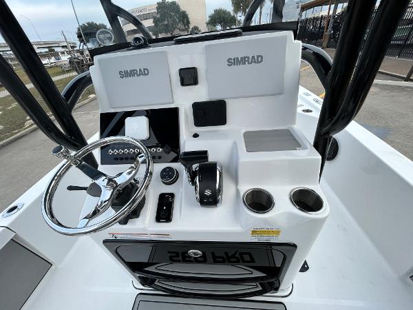 2024 Sea Pro 250 DLX boat console with Simrad electronics and steering wheel.