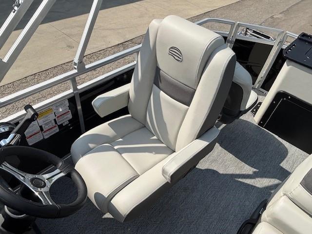 2026 Sun Tracker Fishin' Barge 20 DLX captain's chair with steering wheel, gray upholstery.