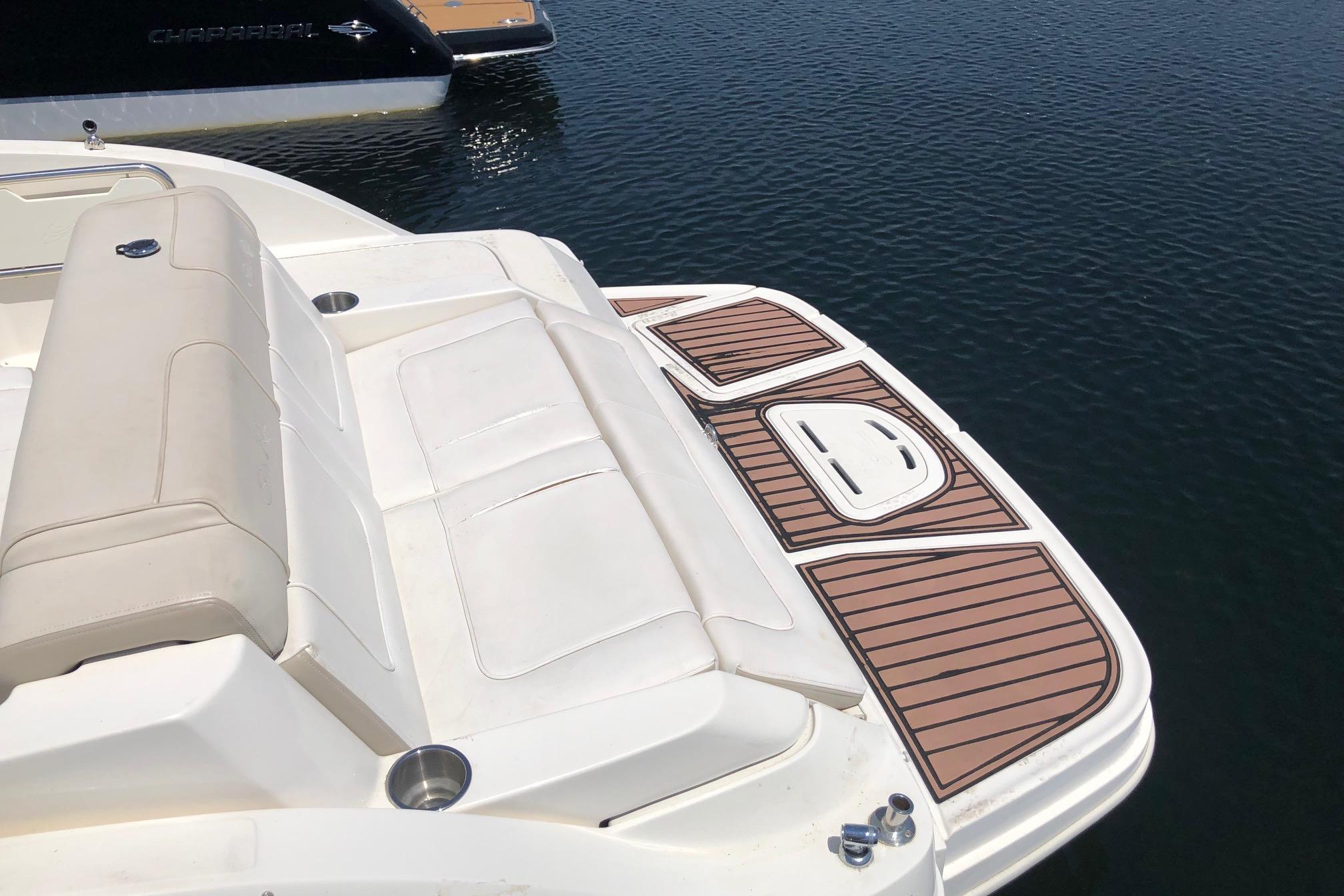 2013 Sea Ray 260 Sundeck boat with spacious seating and swim platform on calm water.