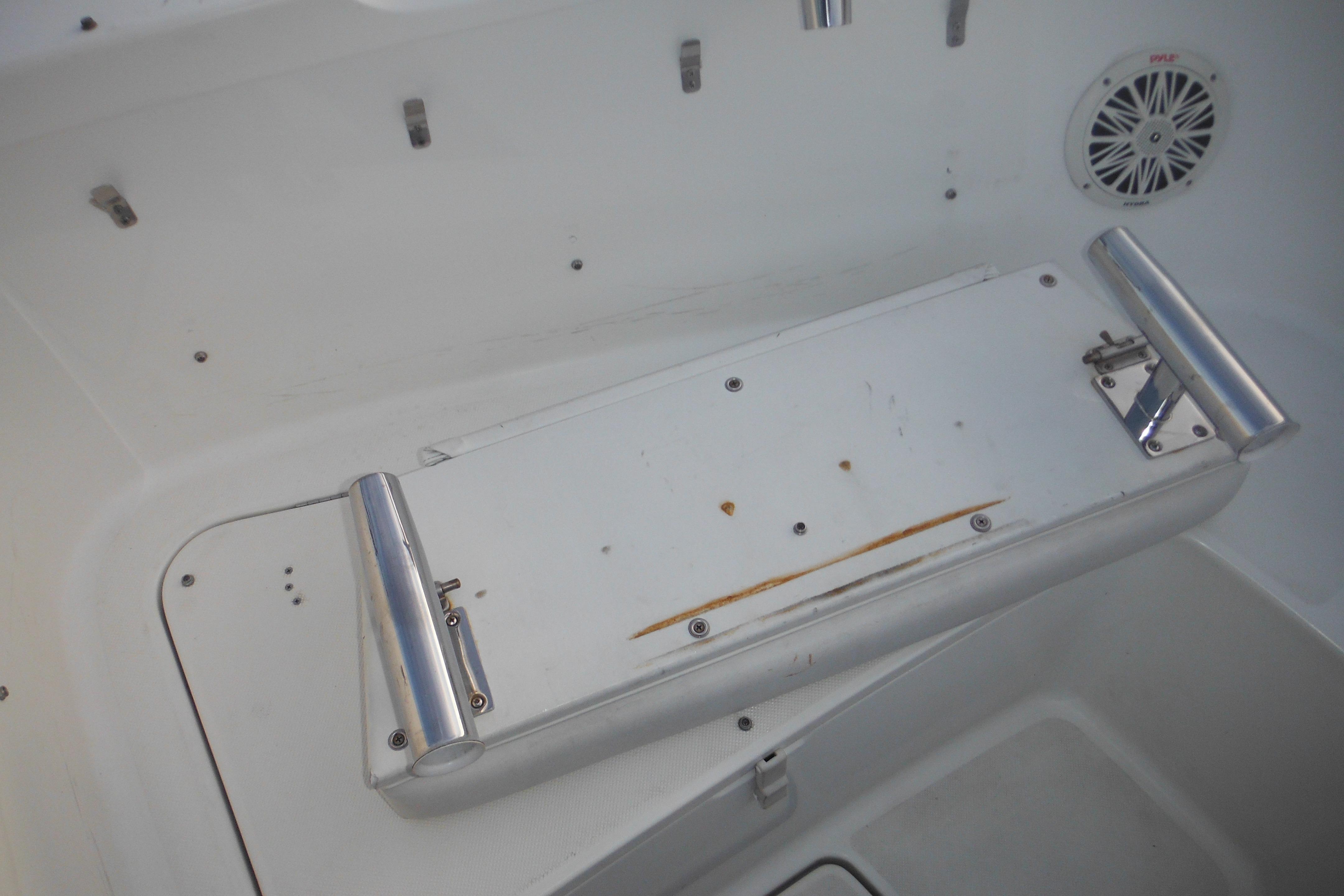 2006 Triton 225 DC boat interior with foldable seat and speaker.