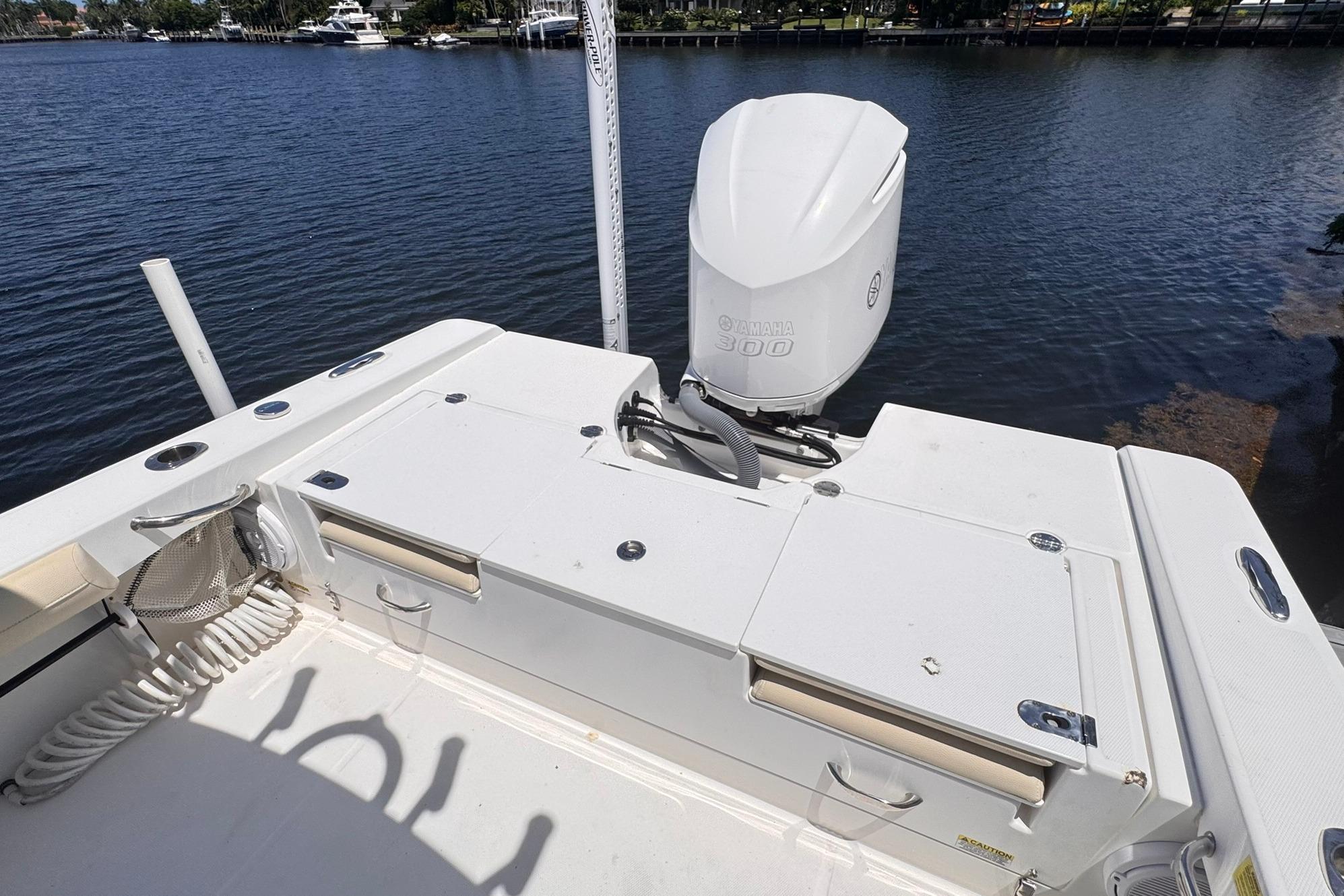 2018 Everglades 253 Center Console boat with Yamaha 300 engine on a calm waterway.
