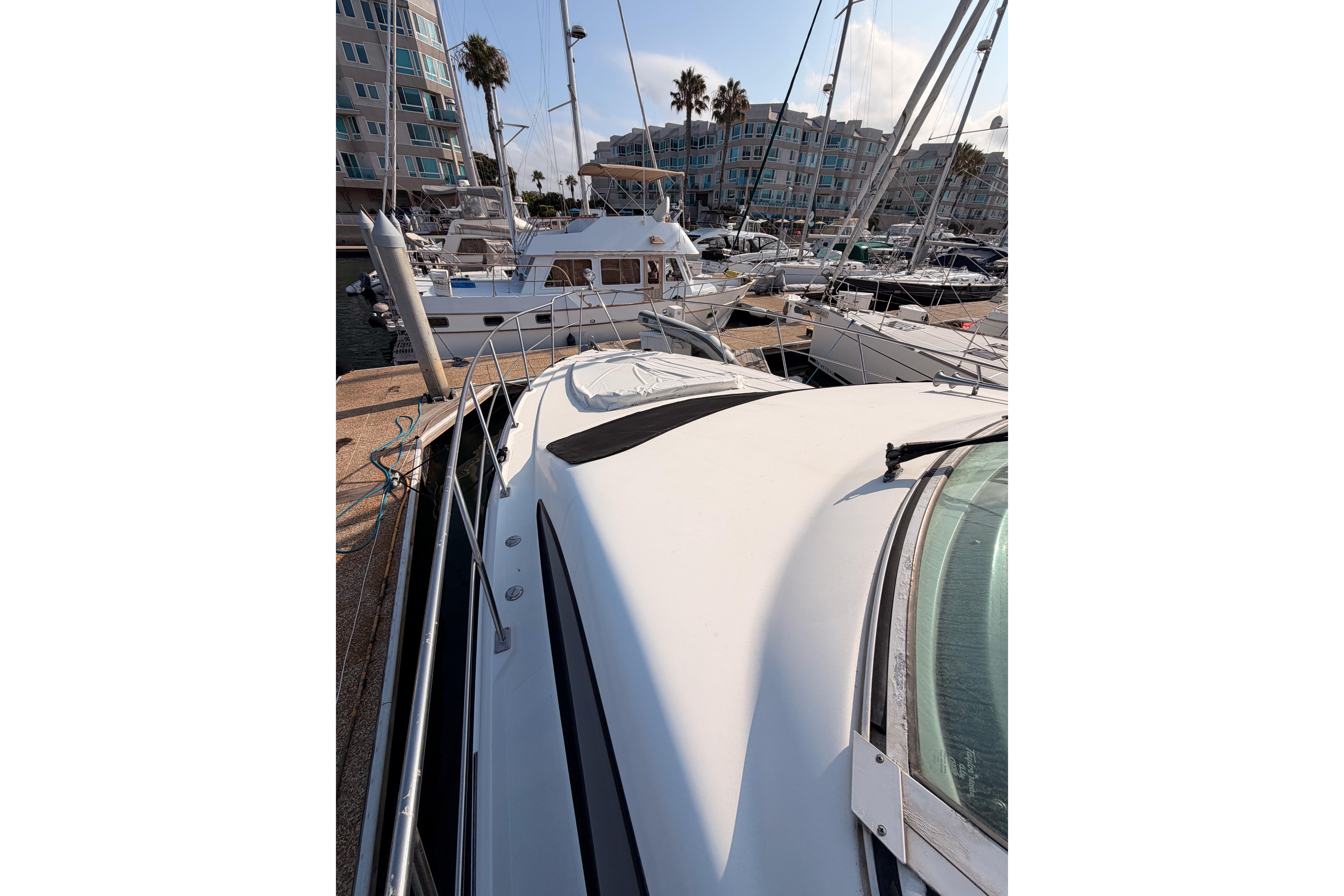 2005 Cruisers Yachts 405 Express Motoryacht docked in a marina with other boats.