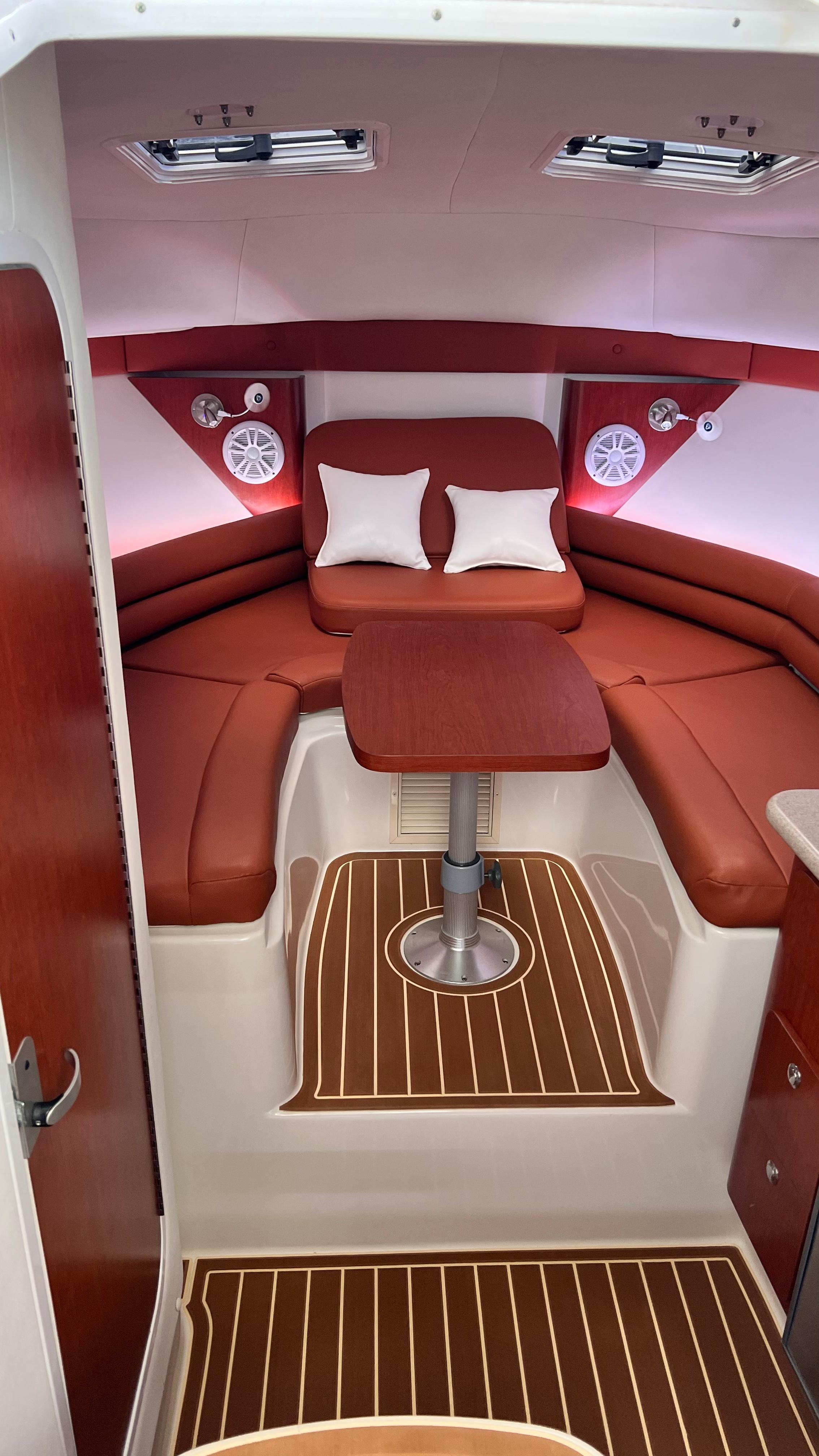 Interior of a Pro-Line 32 Express with red upholstery and wood flooring.