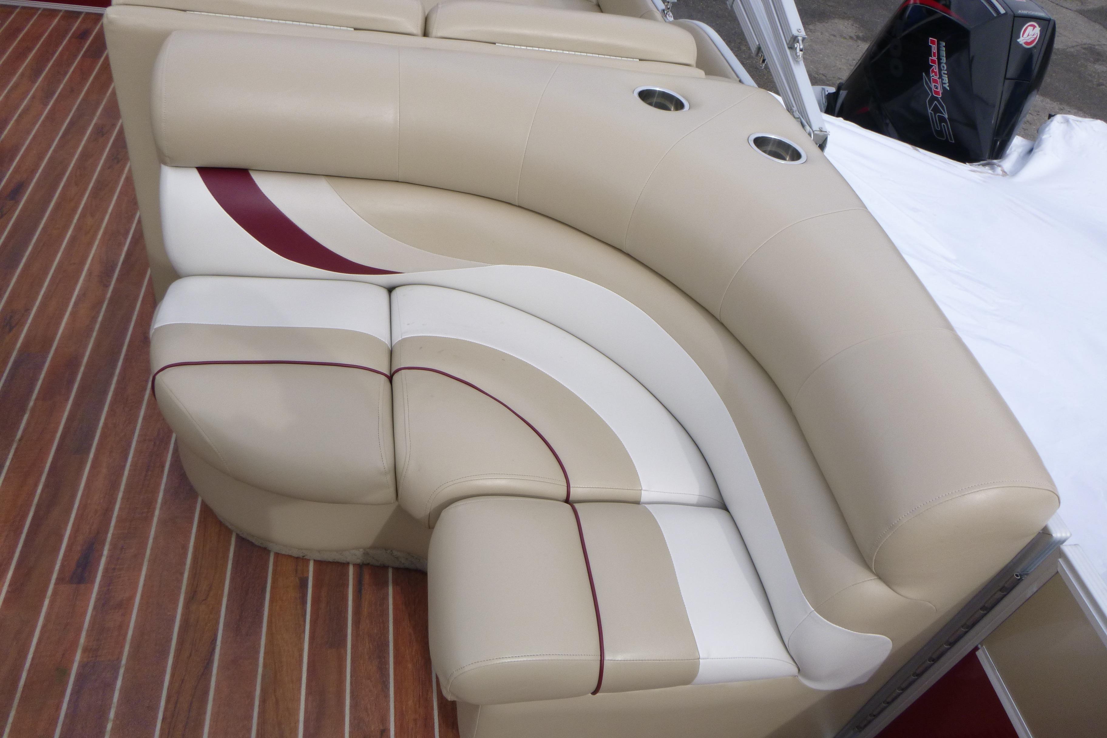 Luxurious beige seating on 2012 Crest 230SLR Classic boat with cup holders.
