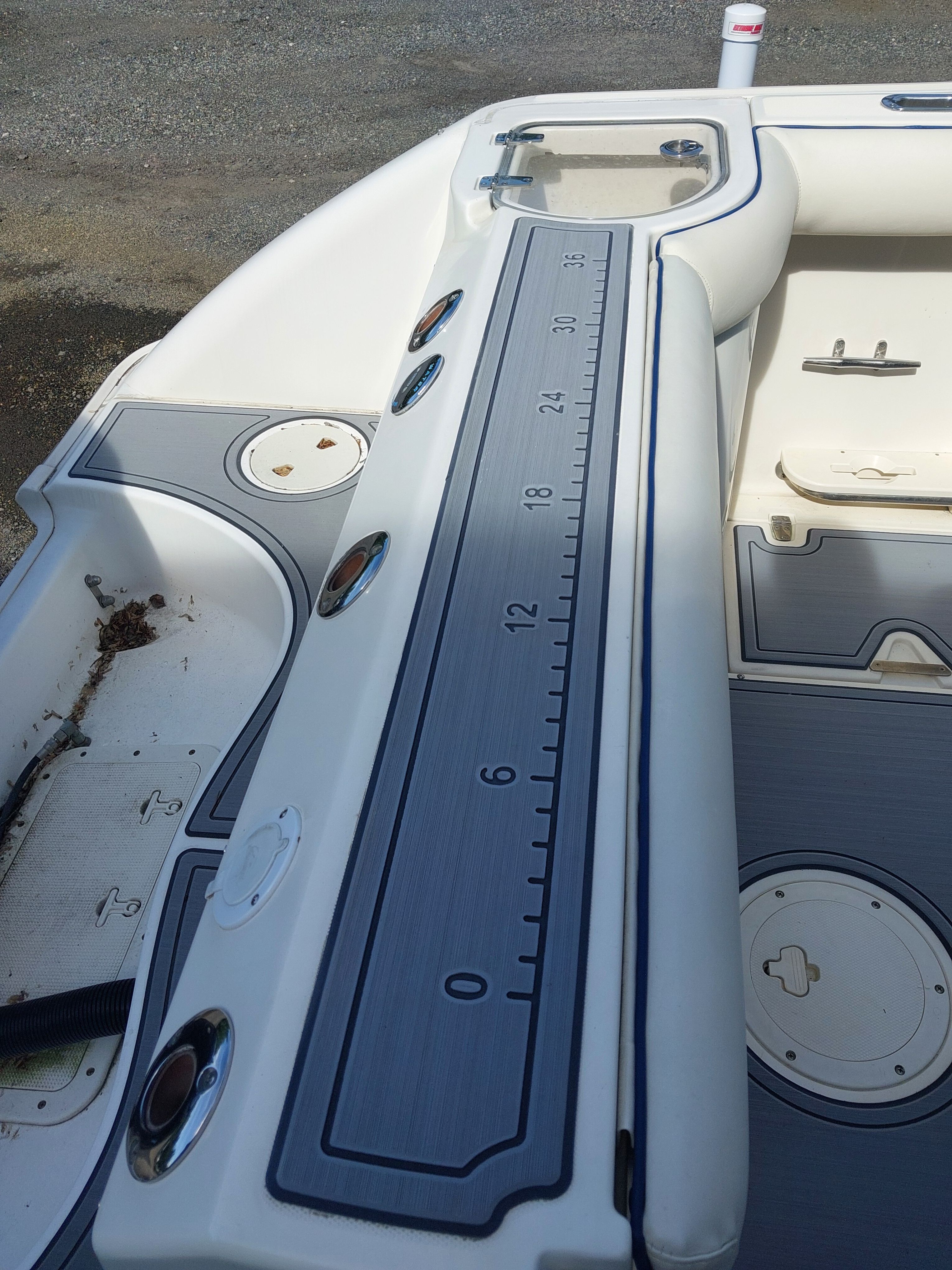 The image shows the deck of a 2005 Boston Whaler 240 Outrage with a measuring scale.