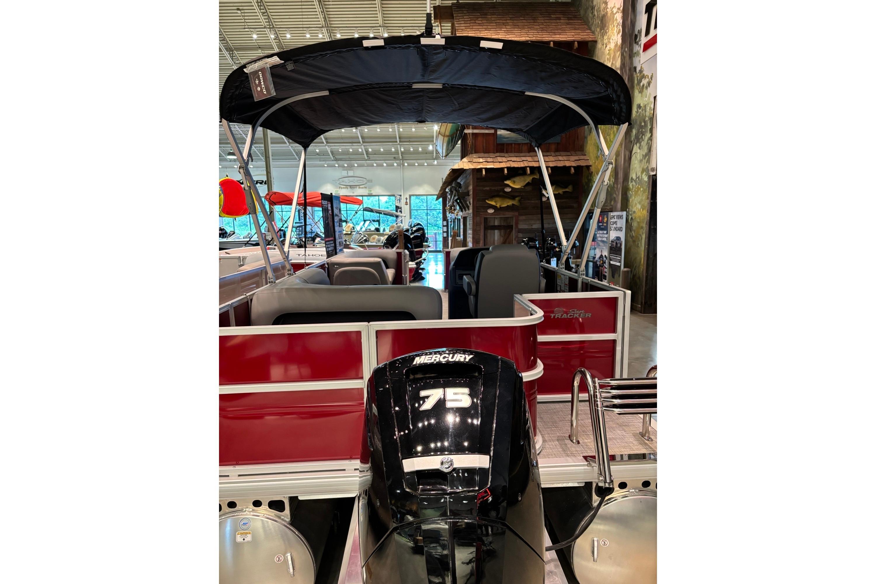 2026 Sun Tracker Party Barge 18 DLX with Mercury 75 engine, indoor display.