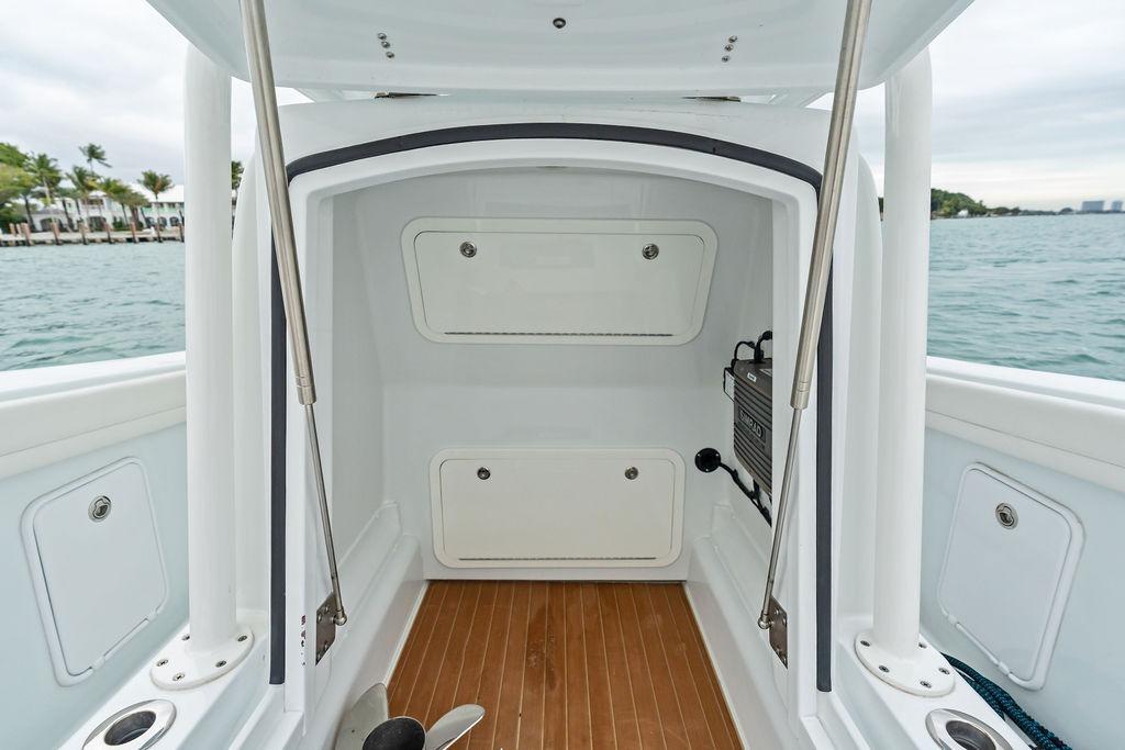 2021 Yellowfin 36 Offshore boat interior with storage compartments and wooden flooring.