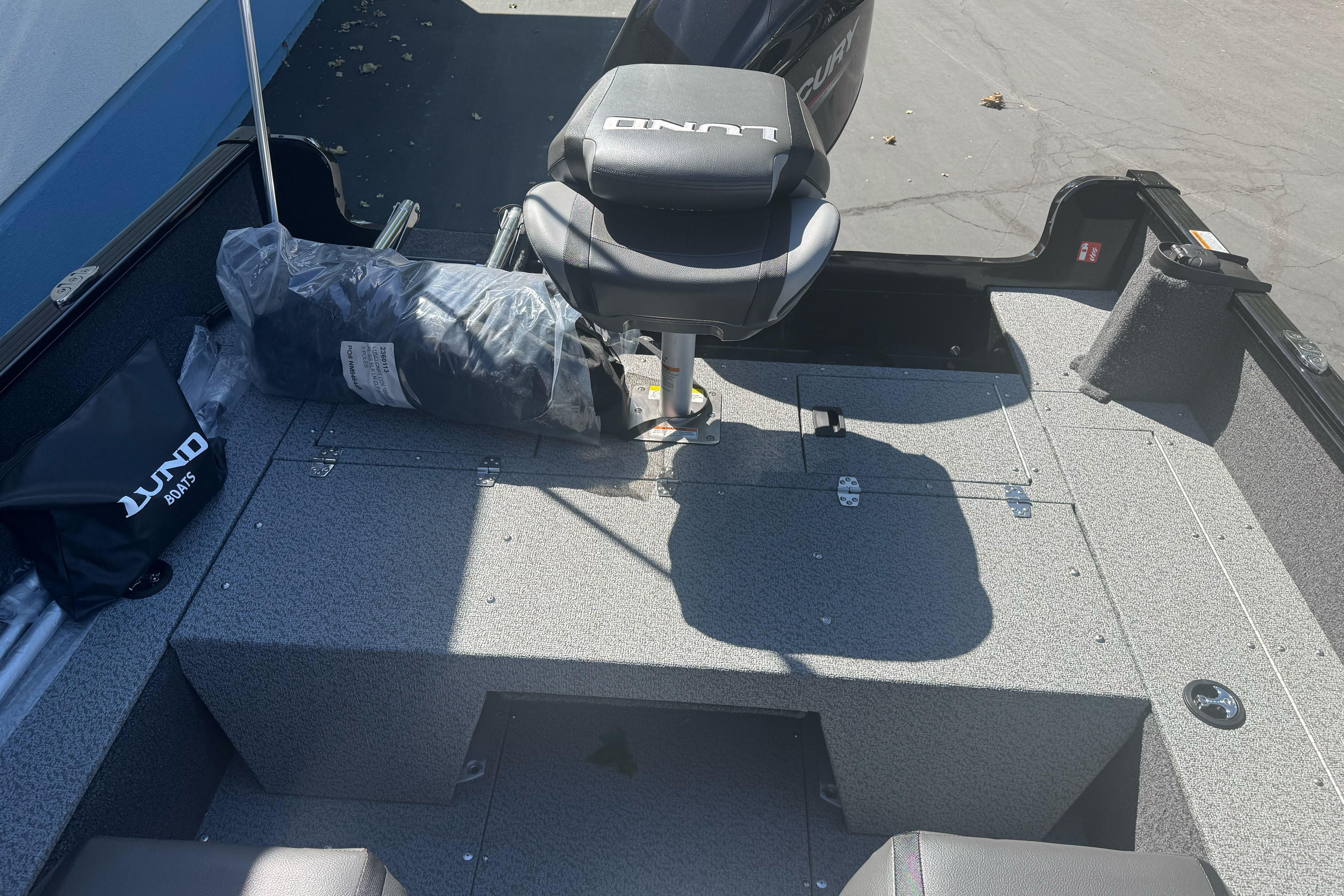 2026 Lund 1650 Rebel XL SS boat interior with seating and storage compartments.