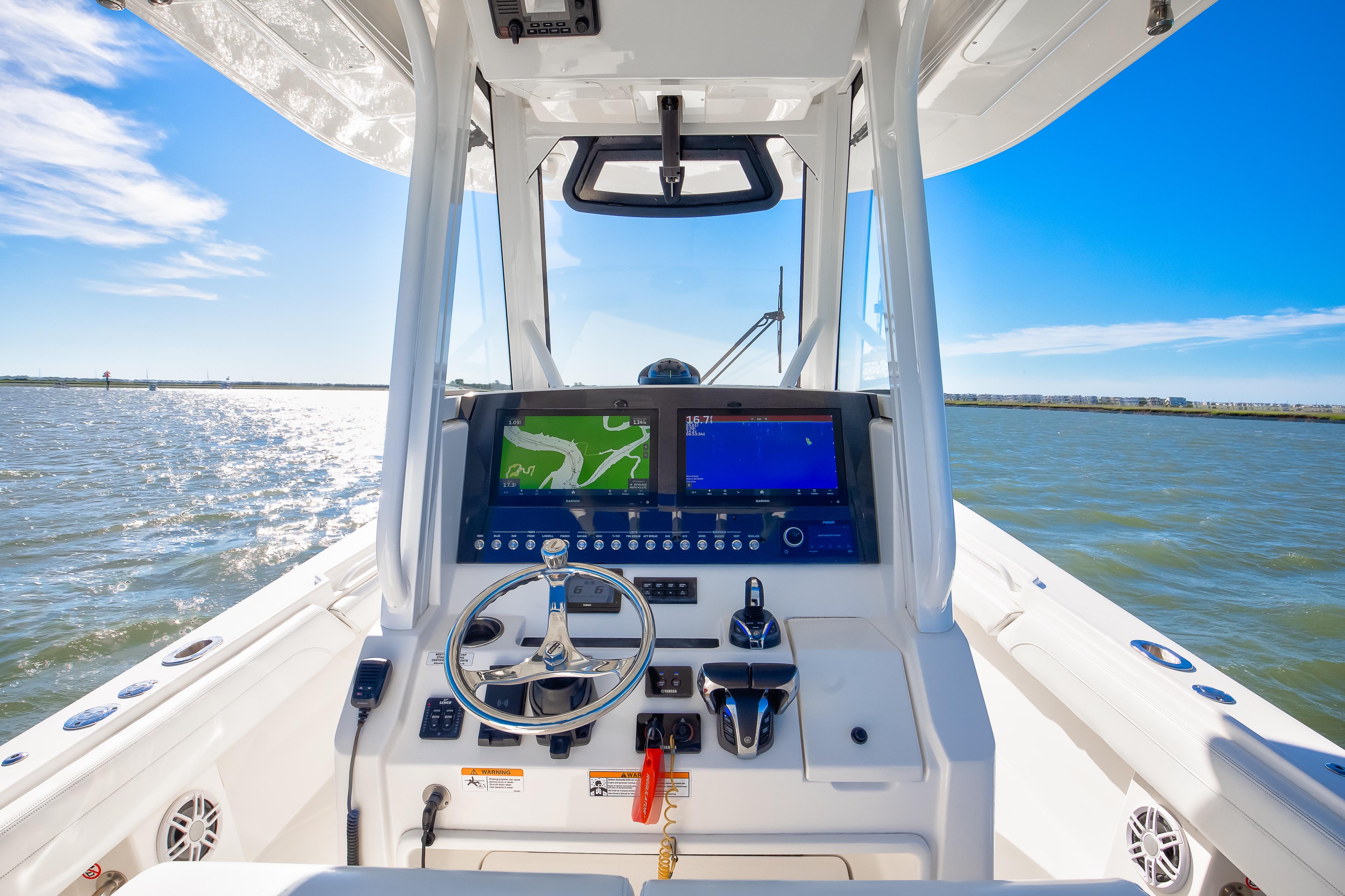 2022 Regulator 28 Forward Seating boat dashboard with navigation screens on open water.