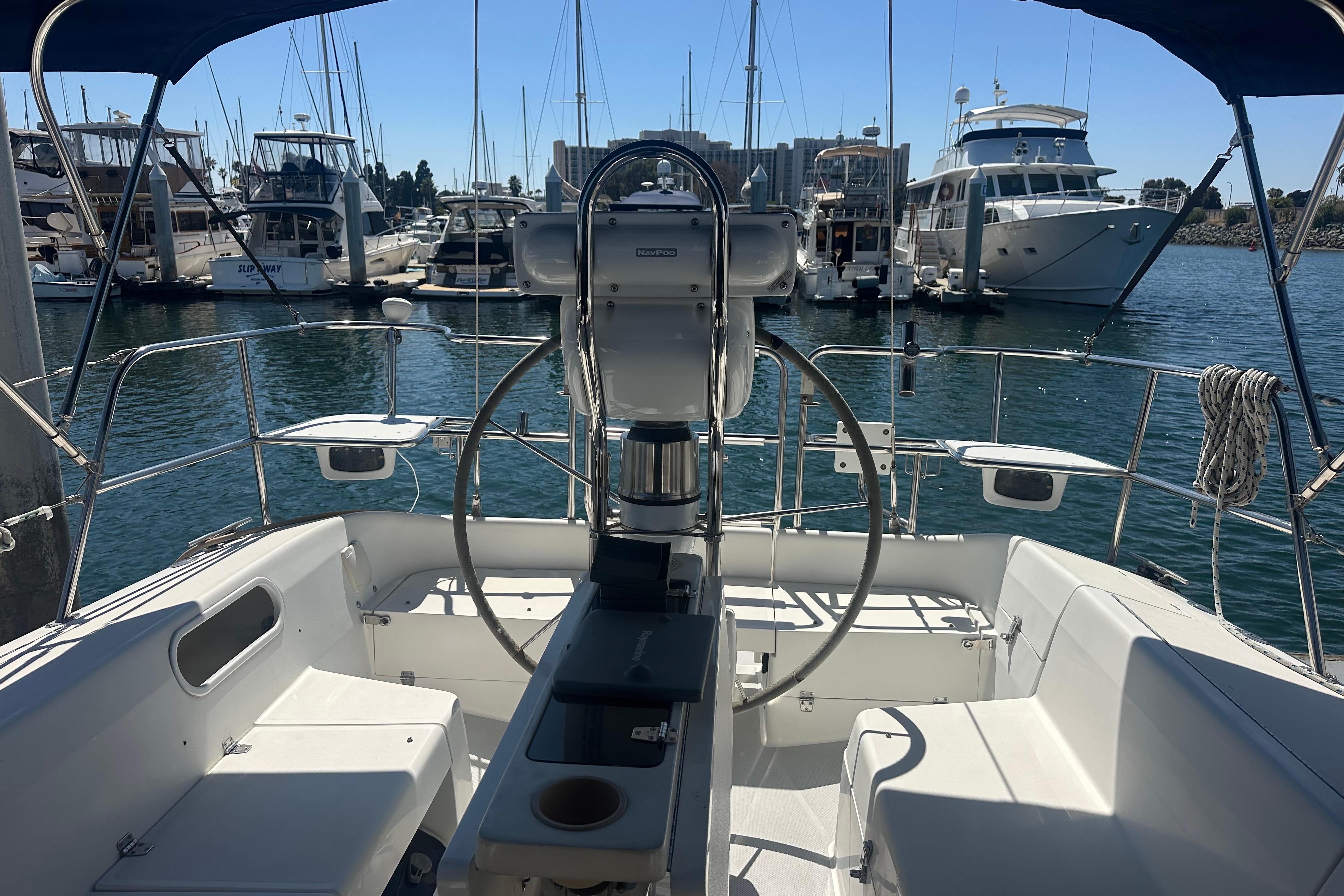 Cockpit view of a 2005 Catalina 36 MkII sailboat docked in a marina.