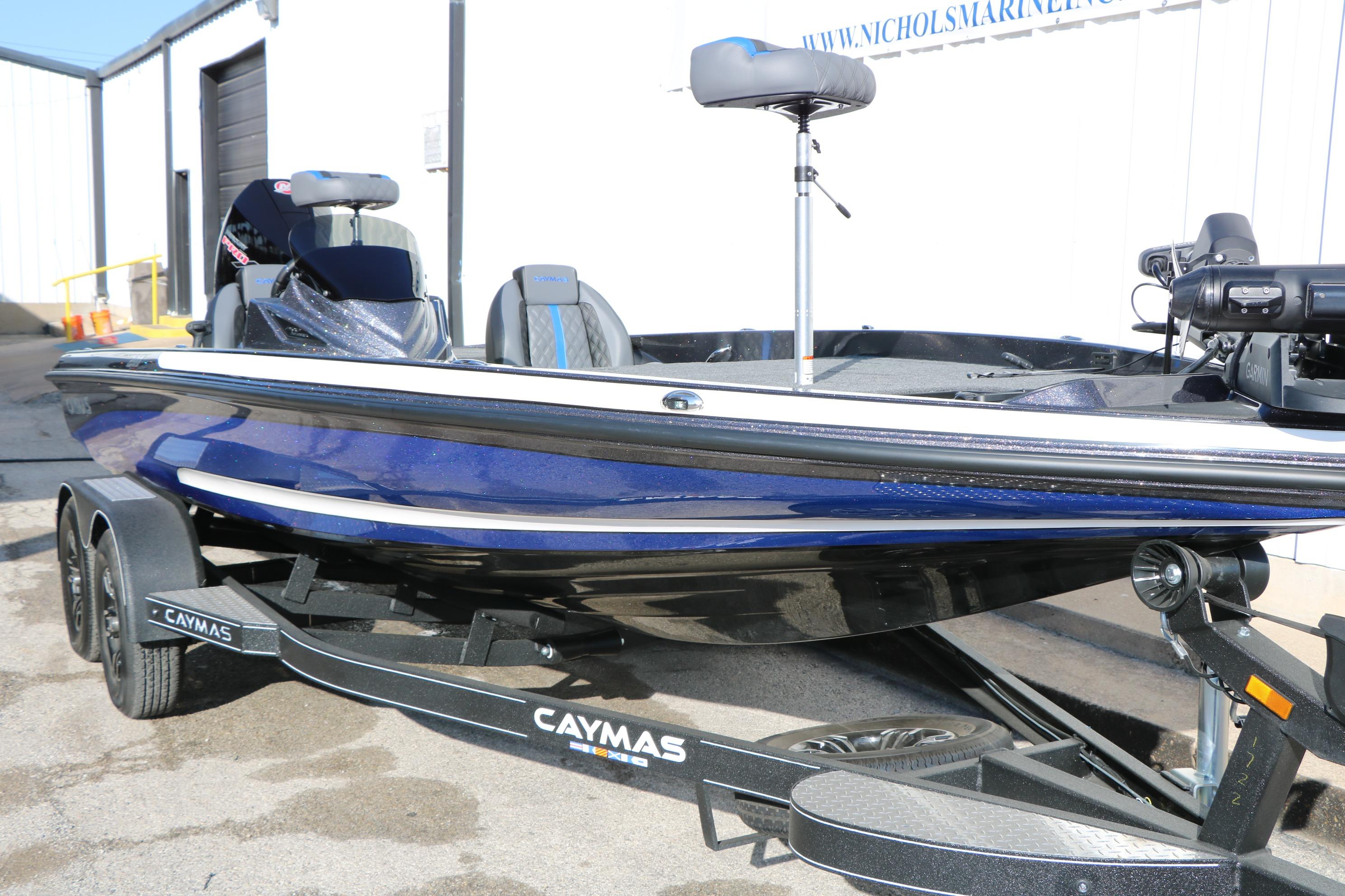 2027 Caymas 201 Pro boat in blue on a trailer, parked outdoors.
