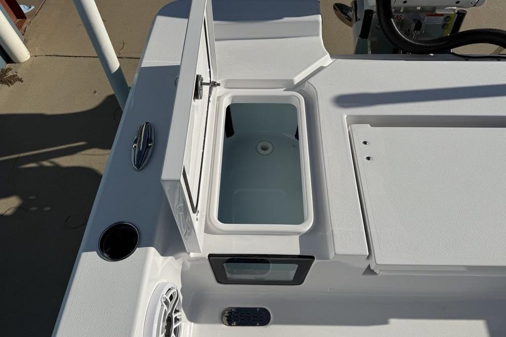 2026 Sportsman Masters 247OE Bay Boat deck with open storage compartment.