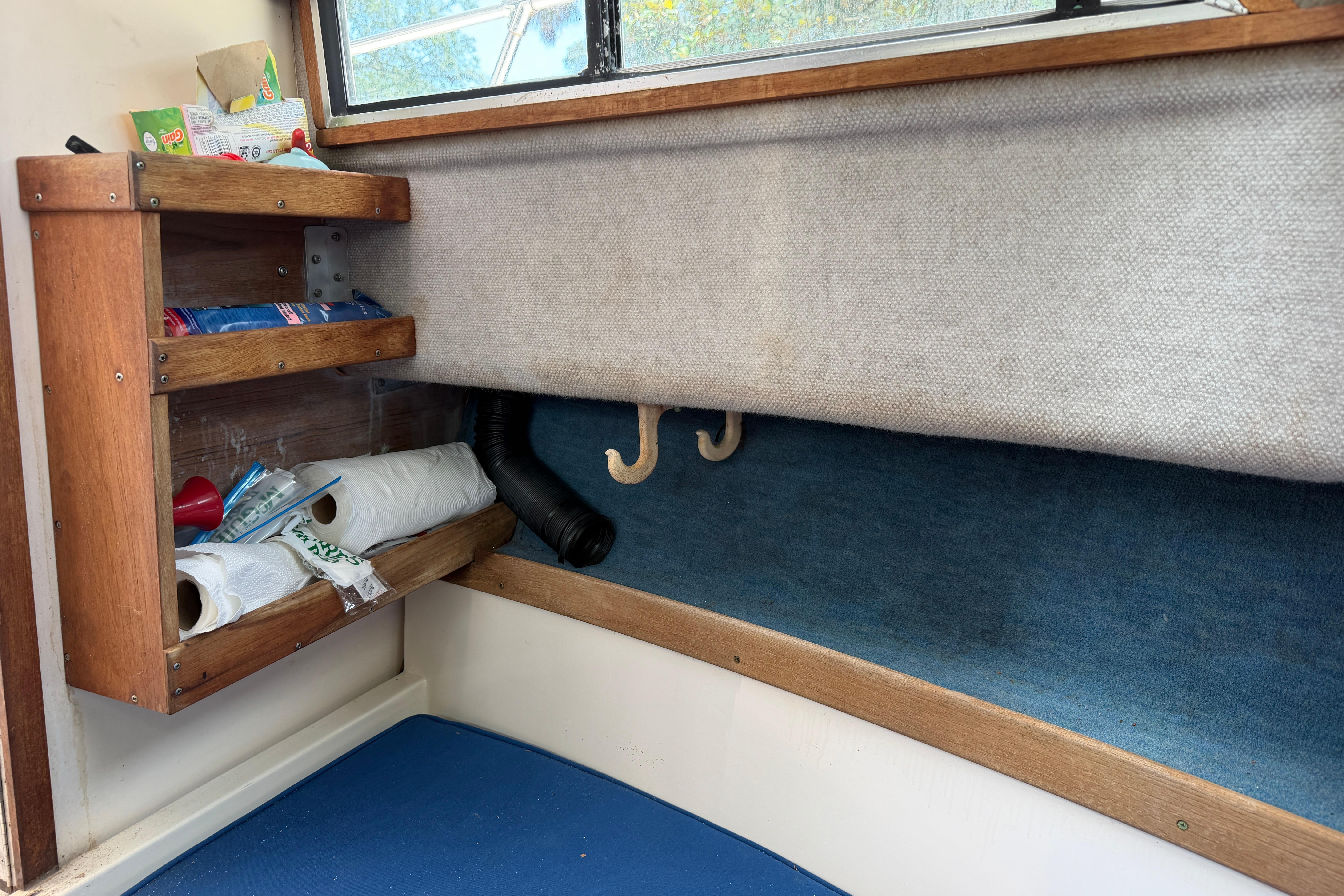 Interior of 1987 Grady-White Seafarer 226 with wooden shelves and storage.