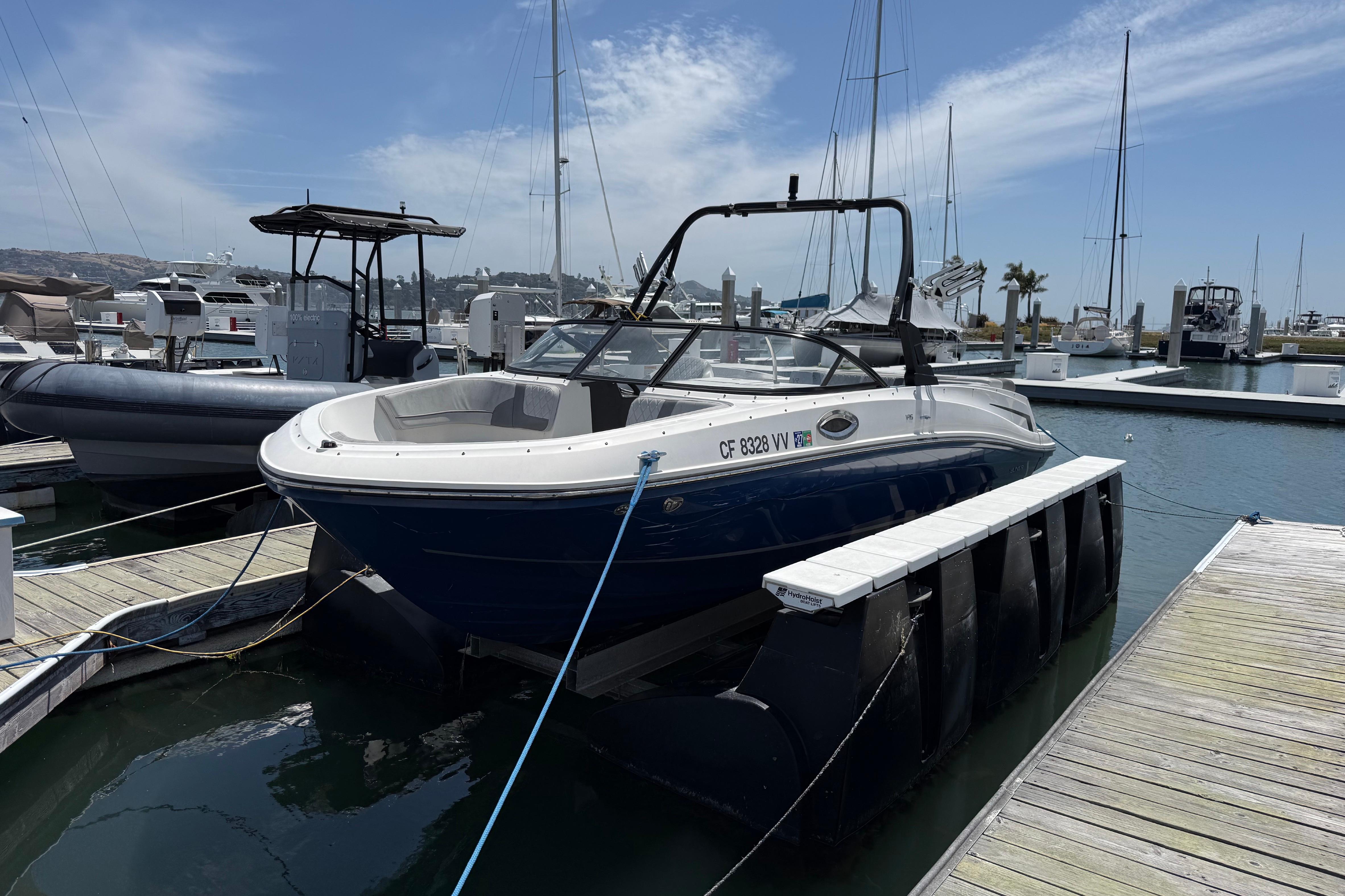 2021 Bayliner VR5 Bowrider I/O docked at marina under clear sky.