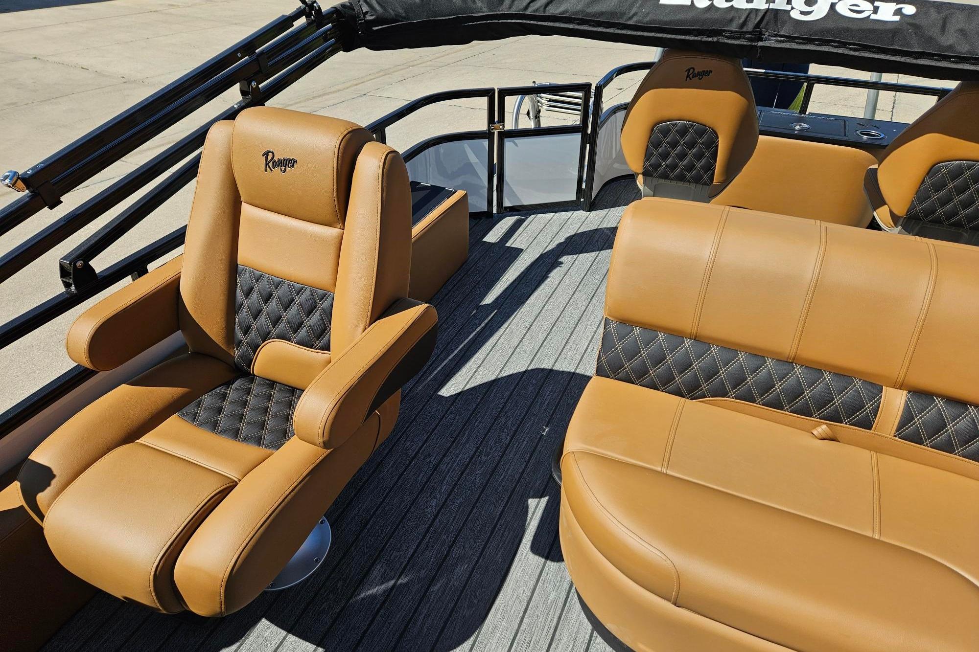 Luxurious tan and black seating on 2026 Ranger 223F boat, featuring premium upholstery.