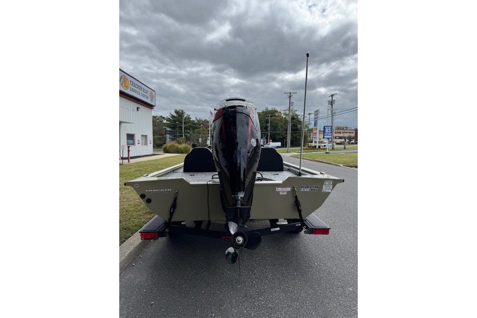 2026 Tracker Pro Team 190 boat on trailer, parked near service center.