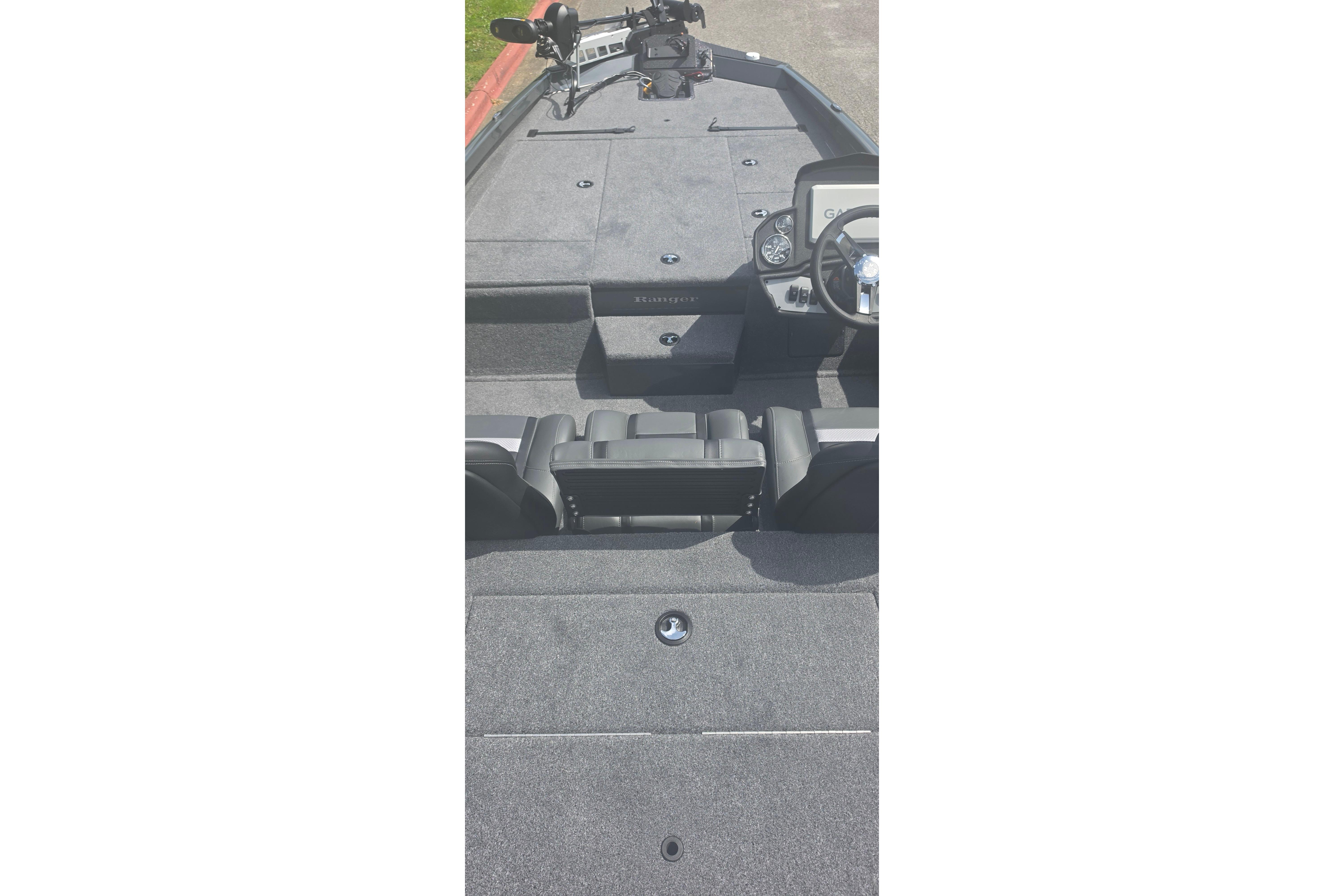 2026 Ranger RT198P boat interior with steering console and seating, showcasing spacious design.