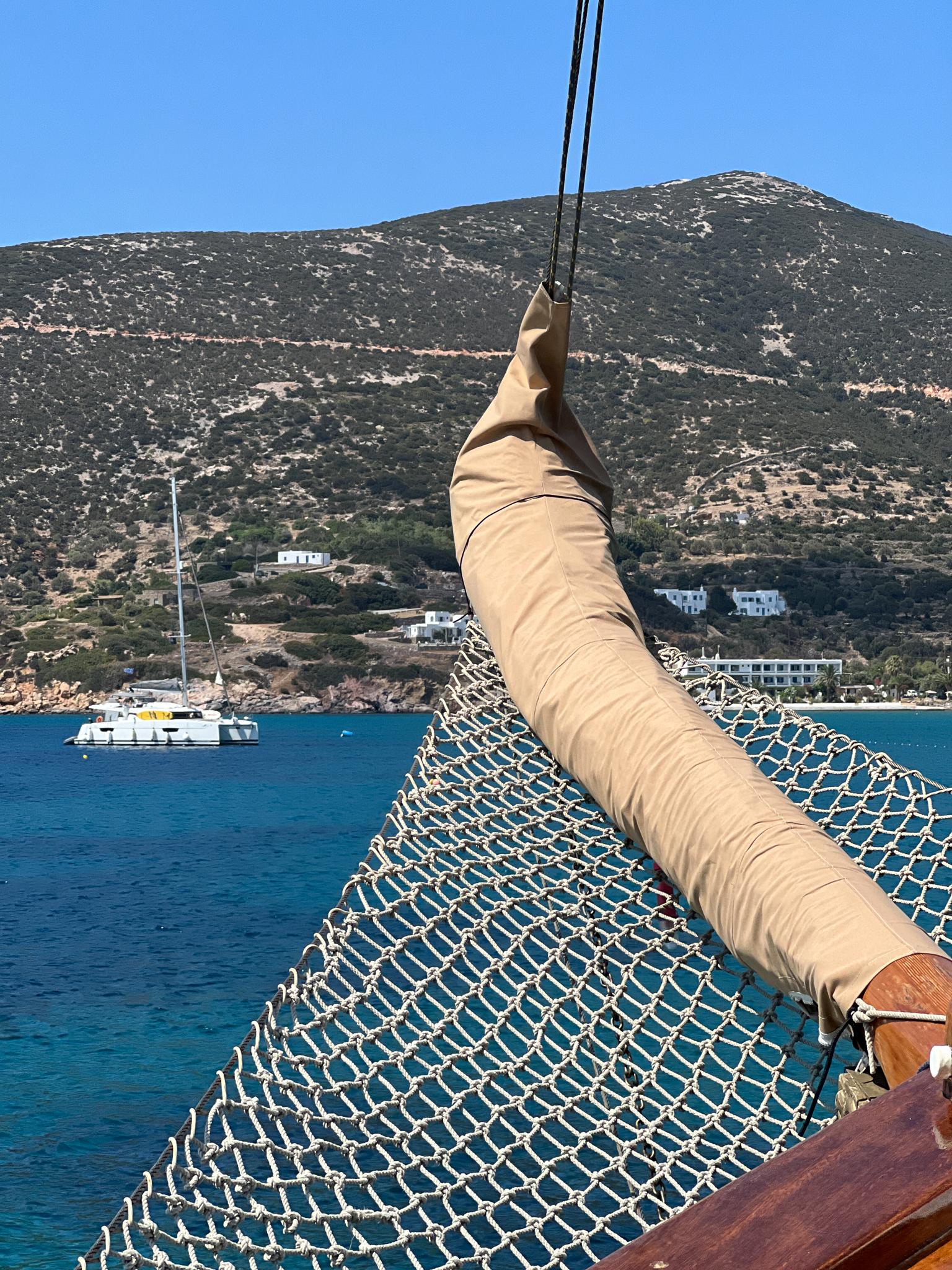 Sailing ship detail with netting, Psarros Shipyard 1969, in scenic coastal waters.