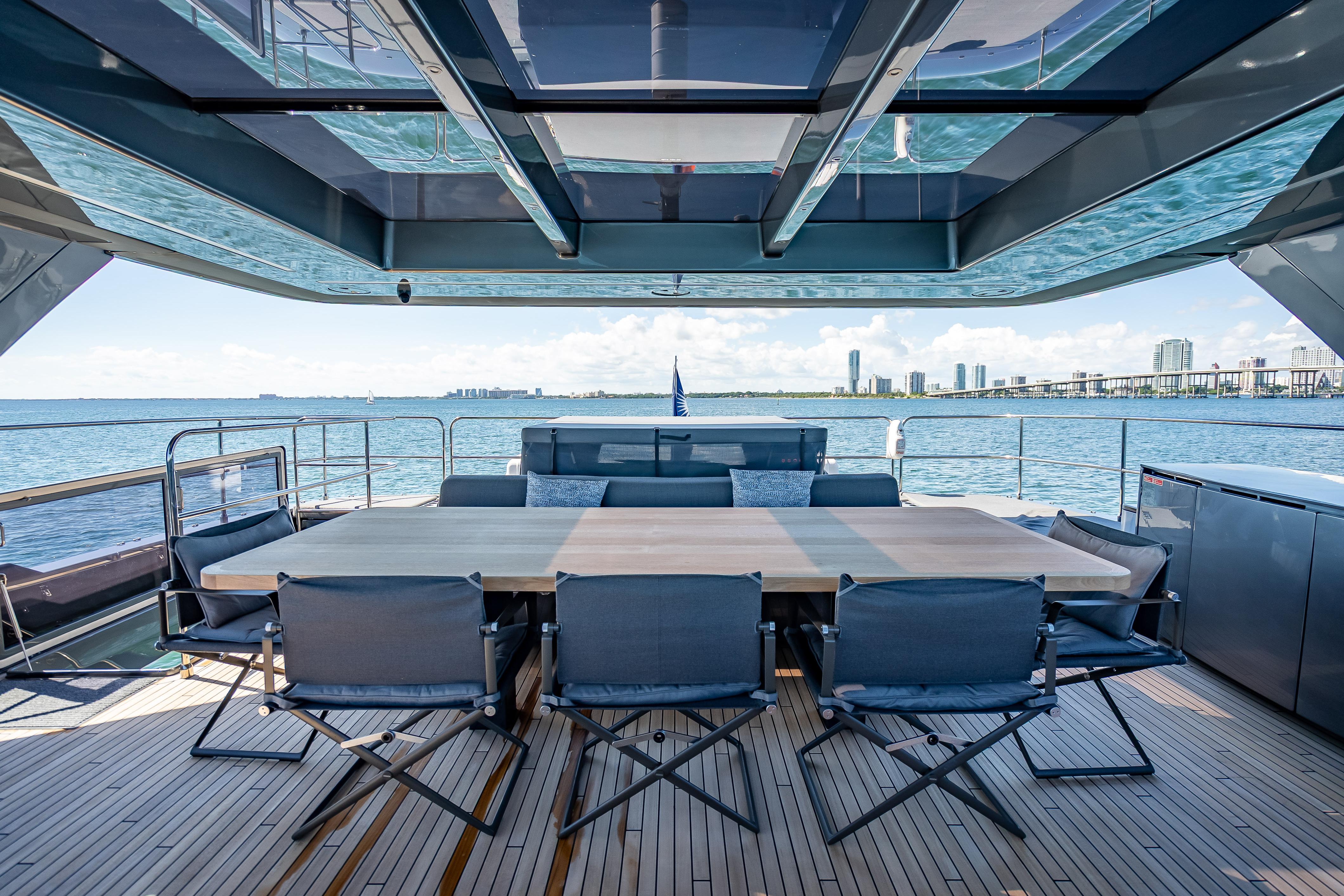 Luxurious Sunreef 60 Power yacht deck with dining area, ocean view, and modern design, 2026 model.