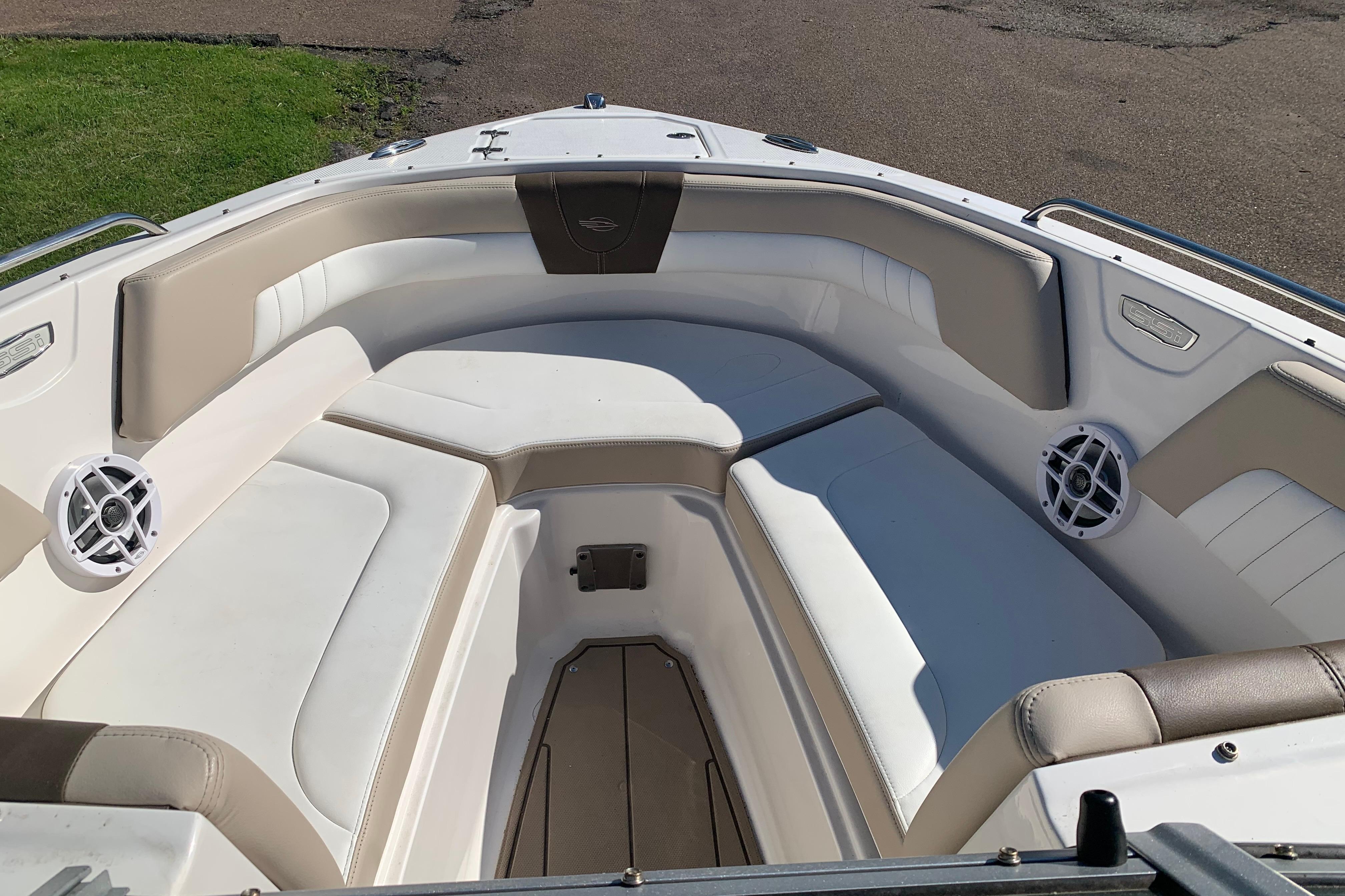2022 Chaparral 23 SSi boat interior with beige and white seating, featuring built-in speakers.