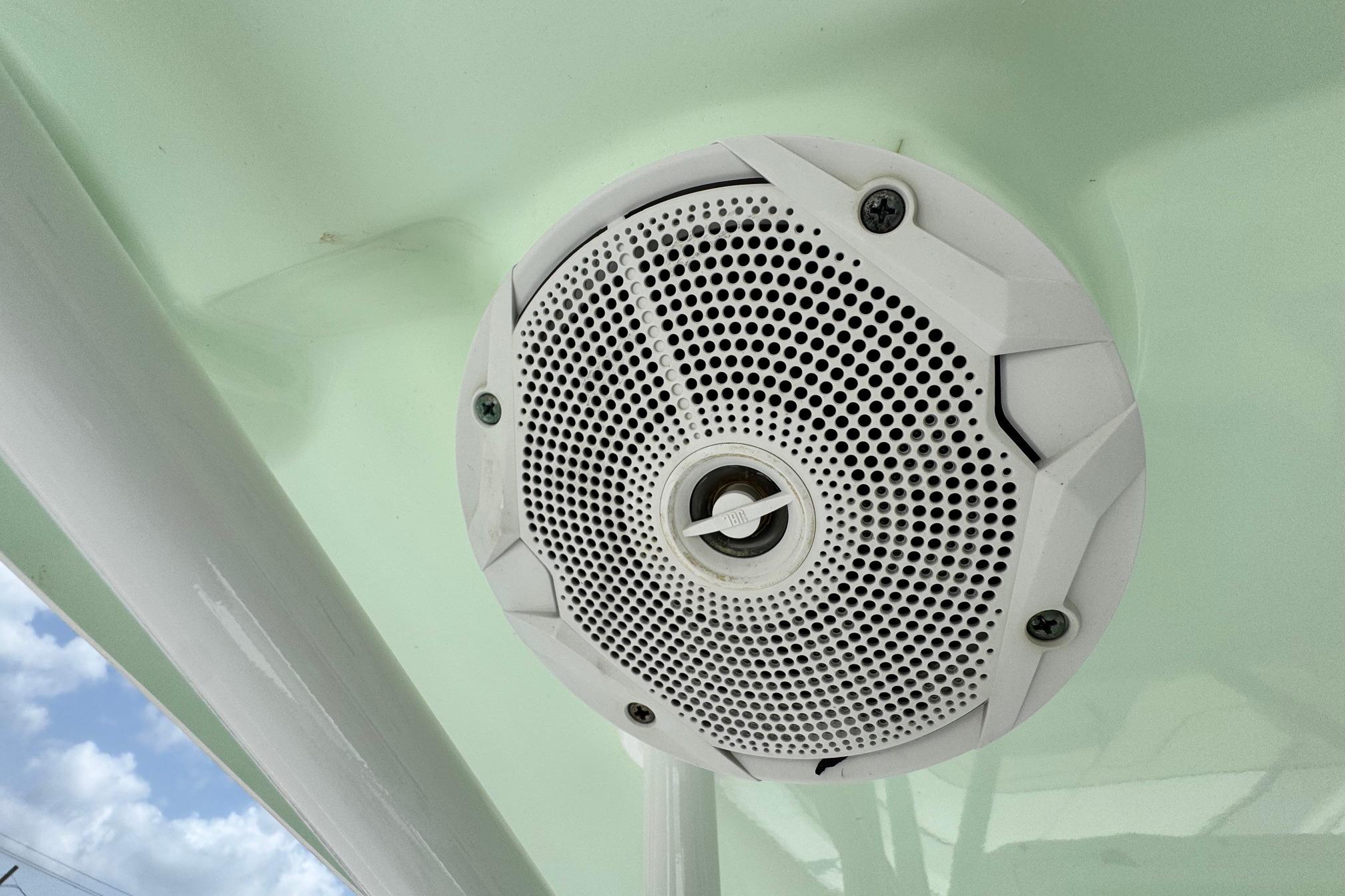 White speaker on 2015 Sea Hunt Ultra 234 boat ceiling, against light green background.