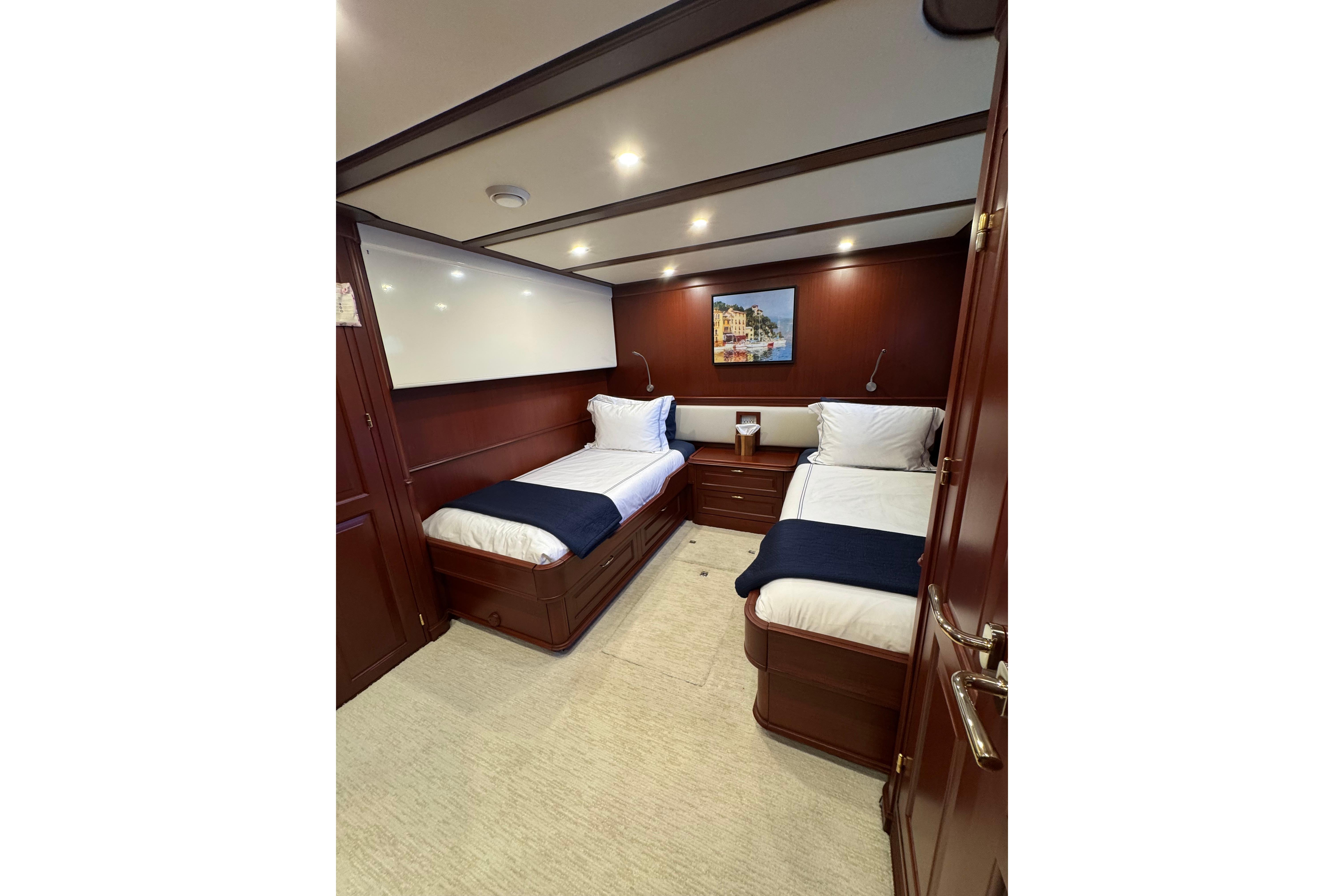 Luxurious twin cabin interior on 2001 Doogersbank Vipack yacht, featuring elegant wood paneling.
