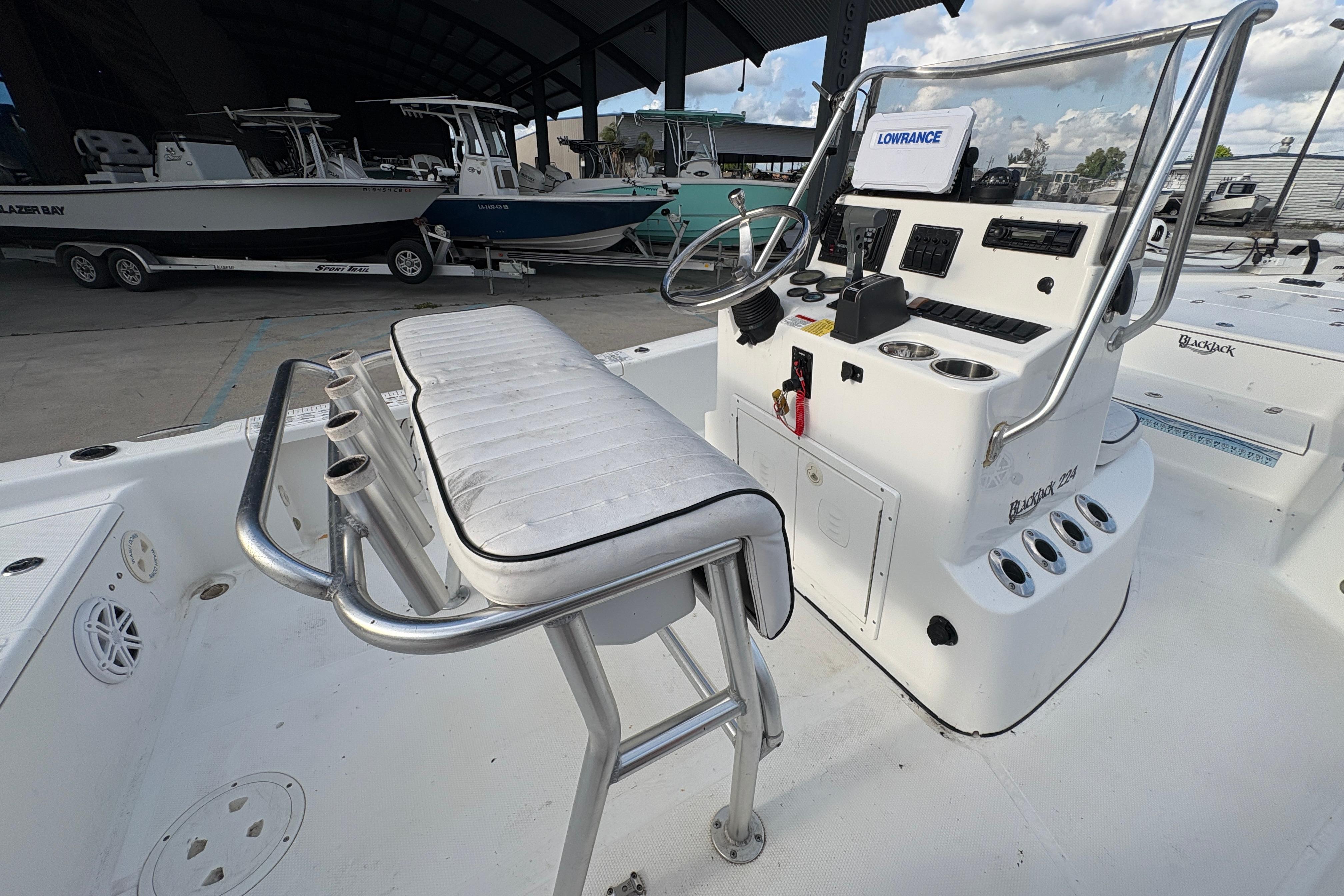 Center console of a 2012 BlackJack 224 boat with steering wheel and controls.