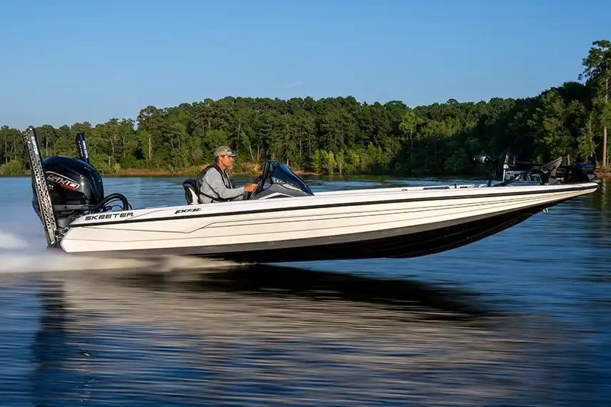 Manufacturer Provided Image: 2026 Skeeter FXR20 FLEX boat speeding on a lake with a driver, surrounded by trees.