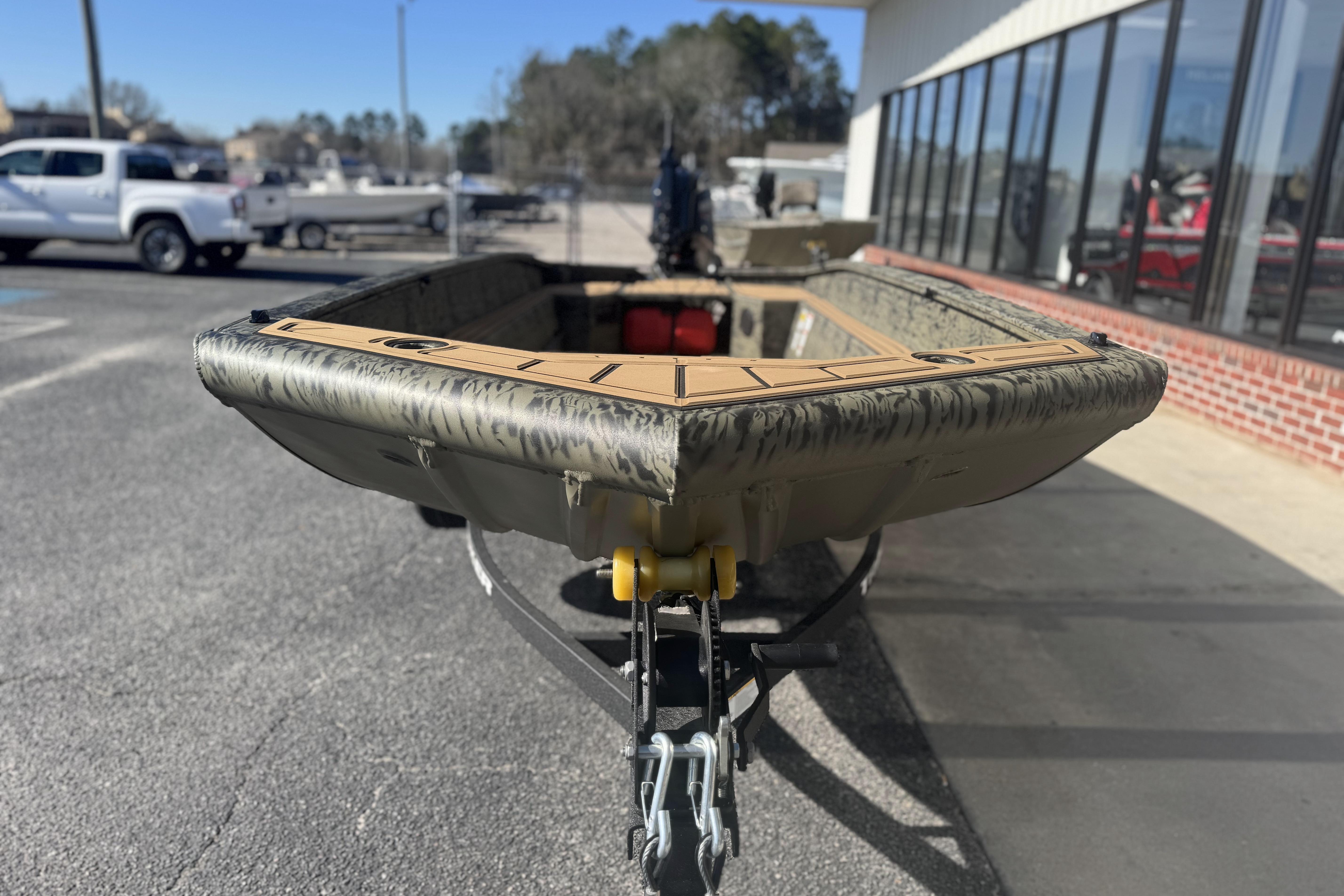 2026 Tracker Grizzly 1650 T Prairie Wings Edition boat on trailer, outdoor display.