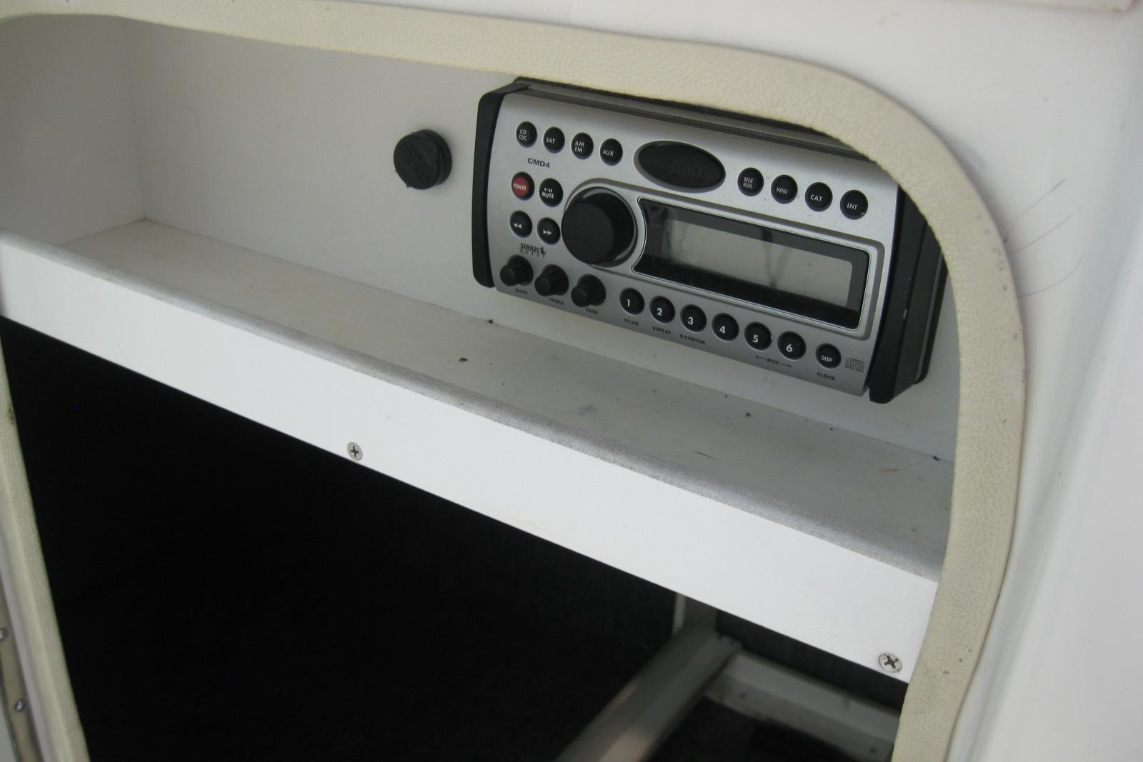 2006 Sea Ray 240 Sundeck stereo system with control panel and display.