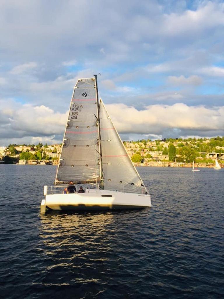 Sailboat on a sunny day, Seascape 27 model, 2018, cruising on a scenic lake.